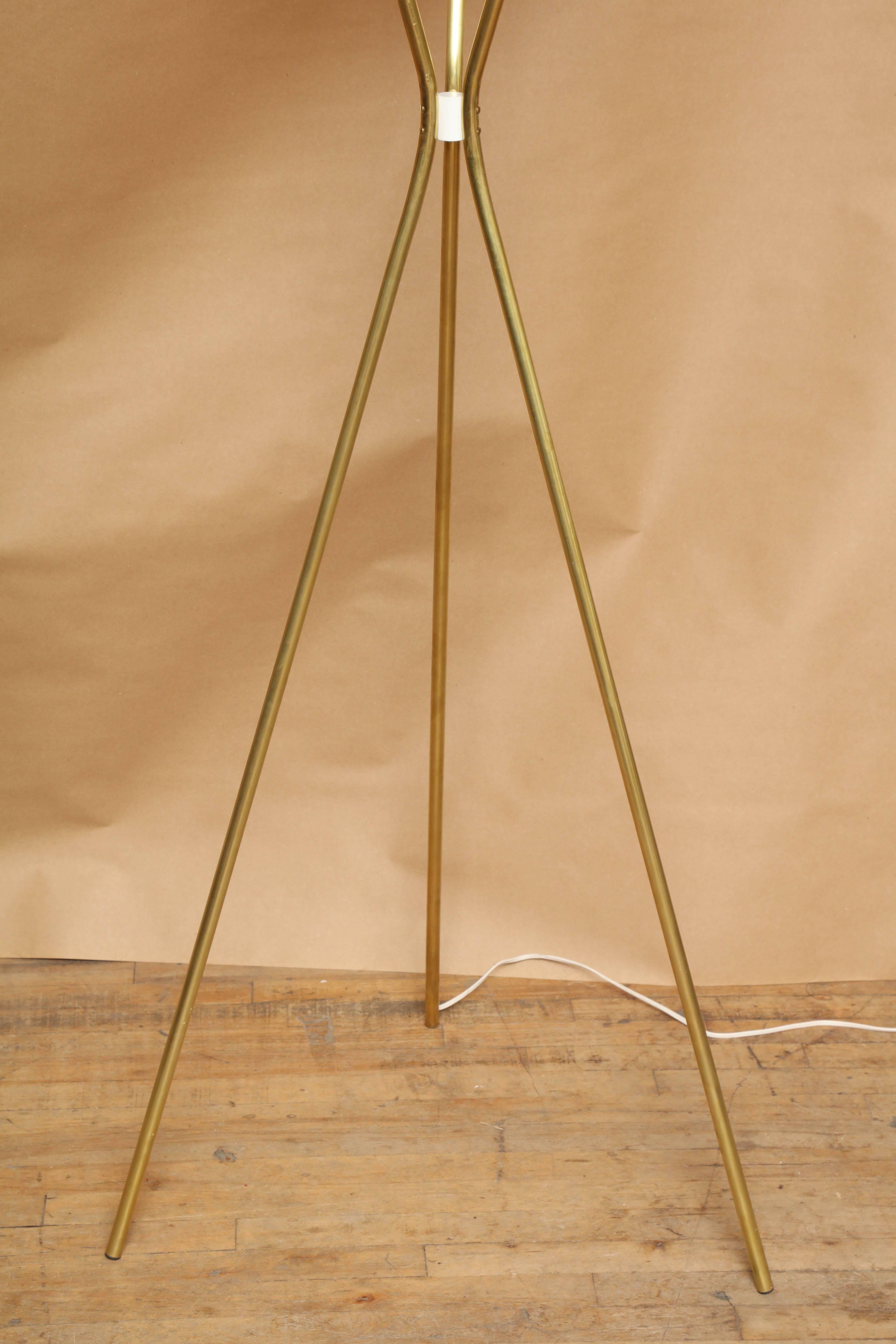 Early Lightolier torchère design by Gerald Thurston, circa 1950s. Newly restored; rewired, handpolished brass tripod base and a freshly lacquered white perforated aluminum shade. Great scale and illumination, by one of the most prolific and