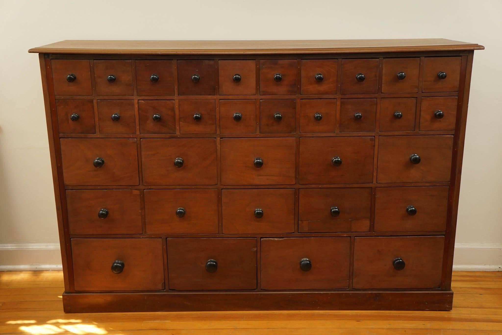 Special, special, special. There are no other words to properly describe this rich mahogany apothecary. 20 drawers on top ten larger drawers in the middle and four larger drawers on the bottom. This is combined with rich black knobs and yes, all the