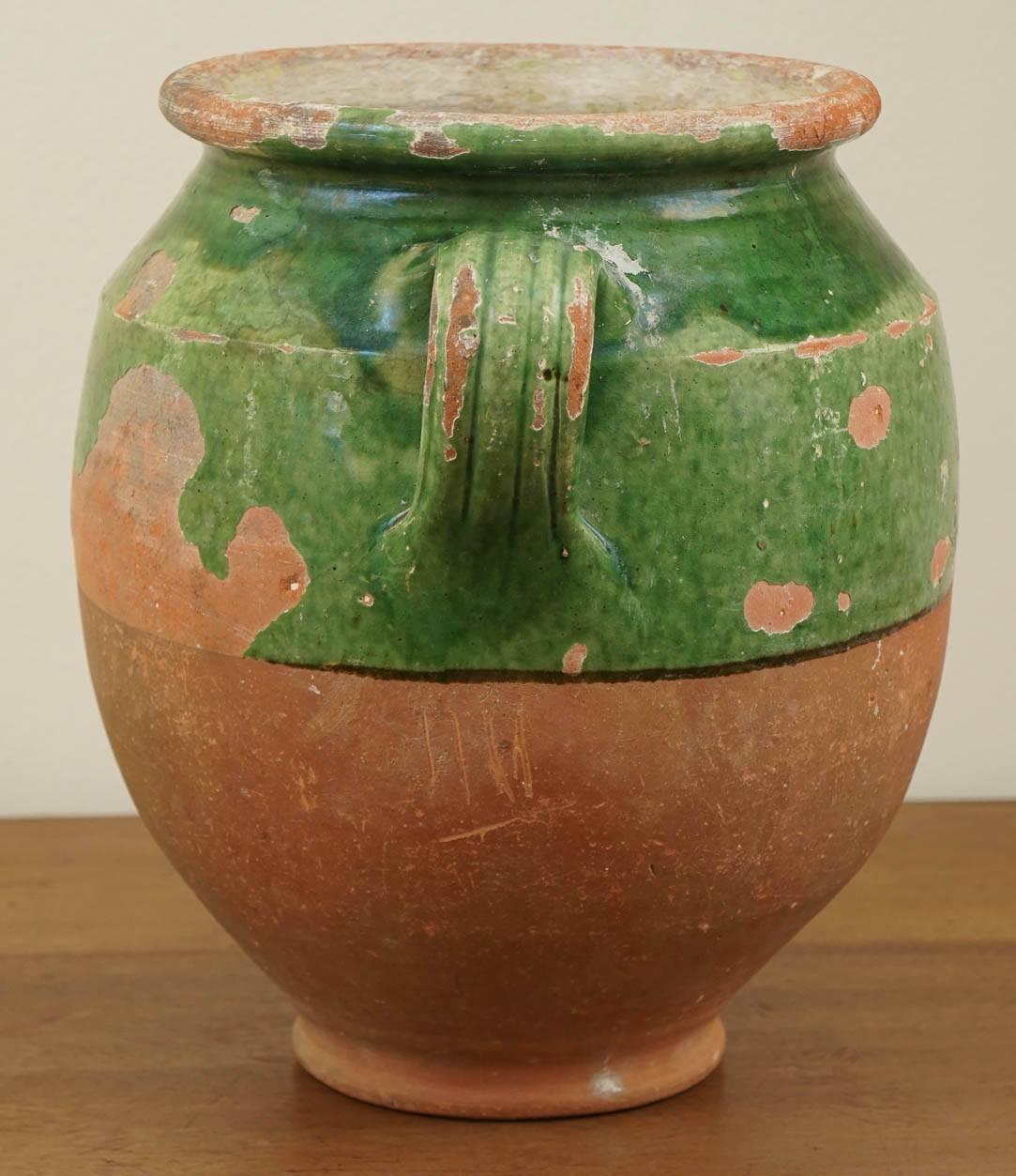 These pieces of pottery were originally used to store confit jars in France. It is more common to find mustard glazed jars but the green ones are more difficult to find. We currently have three green ones and here is one of them. Put a glass vase