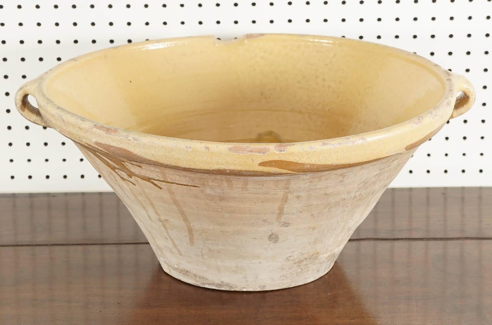 These bowls were used to make batter. The soft lemon color on the inside is beautiful and these batter bowls came with two handles to hang and S-spout to pour without holding by tipping the bowl on its side. How beautiful would these piece be for a