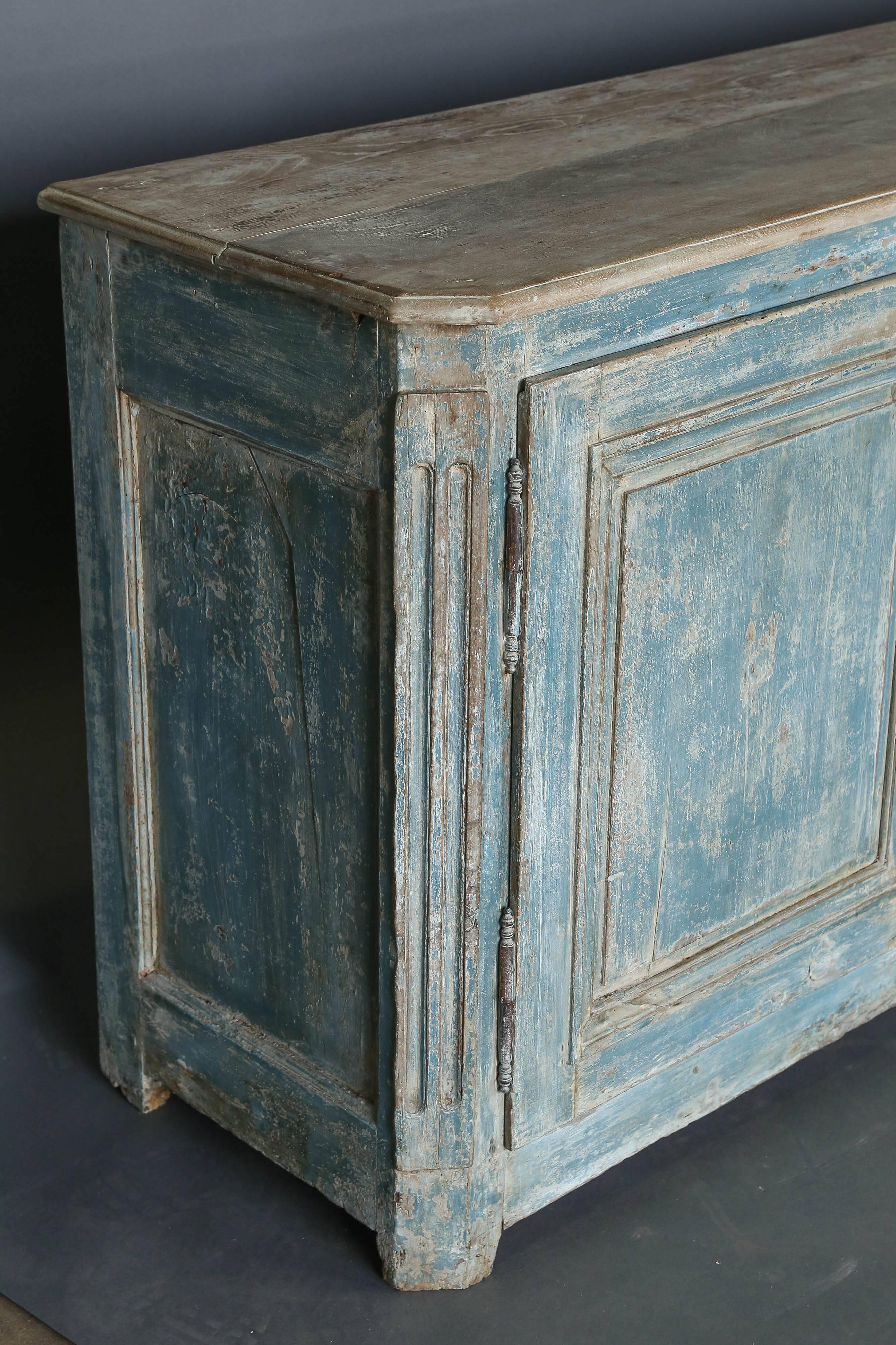 Beautiful 18th century three-door dry scraped paint enfilade or long buffet with Chamfered edges at the corners and grooved line detail. Top of piece has no paint on it and is just the natural wood. There is a small drawer at one end of the piece.