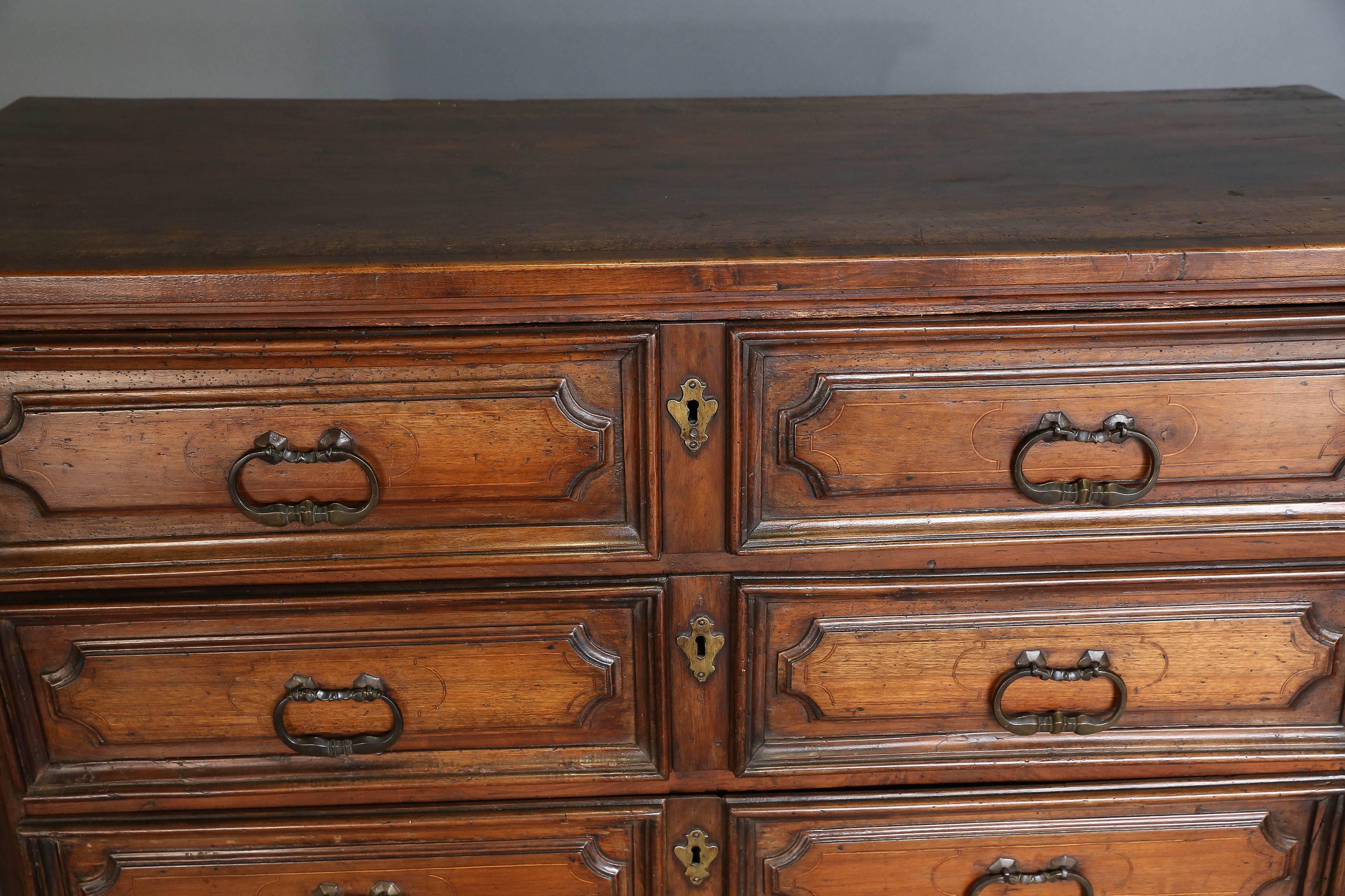 Antique 18th century Italian walnut chest of drawers with four drawers and original hardware on bracket feet. Beautiful patina.