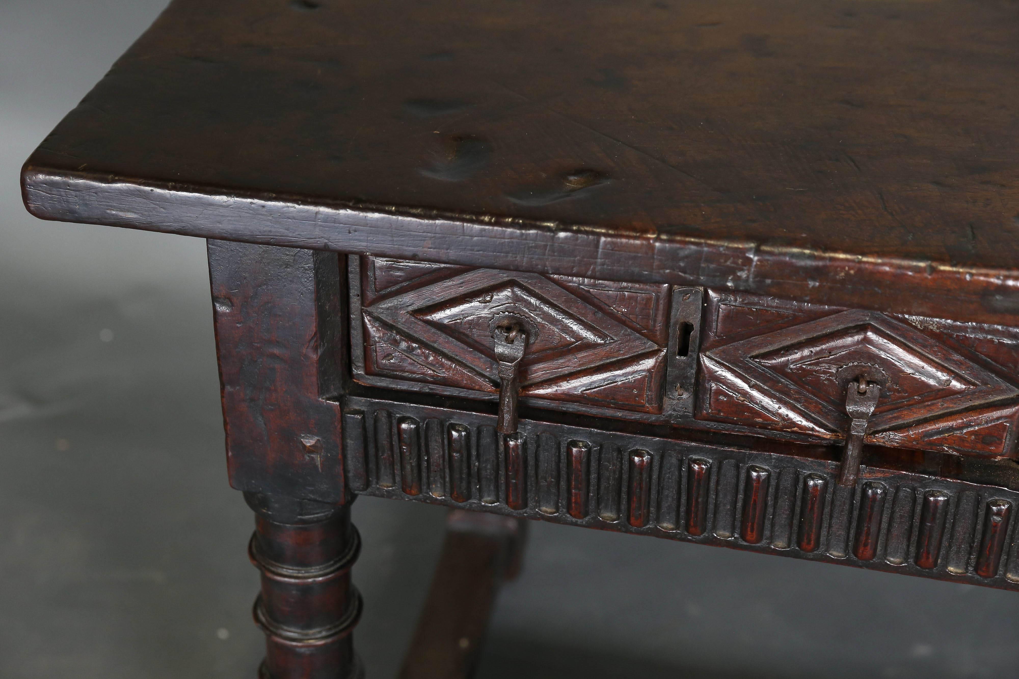 Antique 18th century Spanish console table with two carved drawers and a single plank top. Beautiful patina, architectural carving on drawers, original hardware and turned legs.