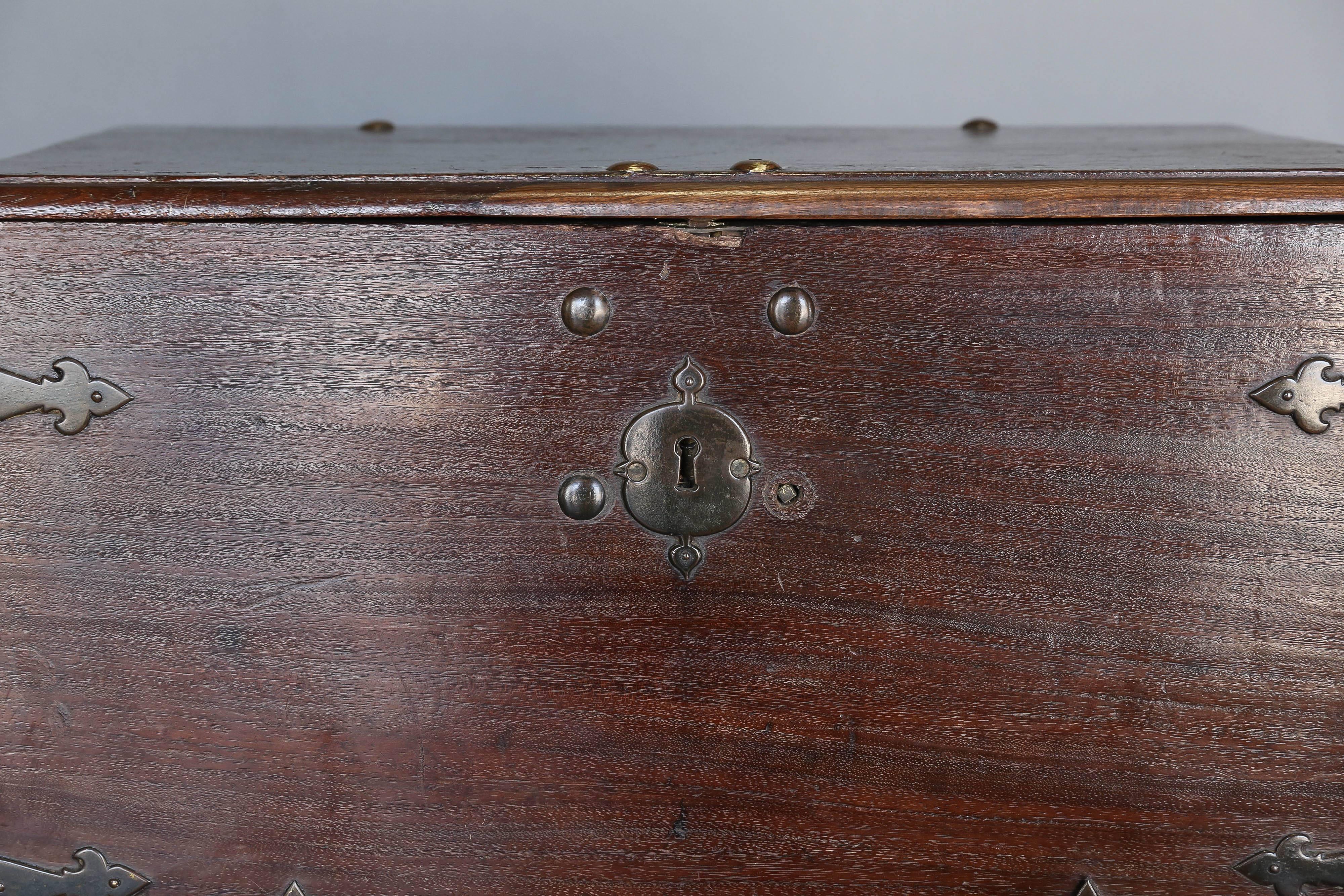 18th century Colonial Dutch chest on metal stand with original hand-wrought hardware. Beautiful handles on side of trunk with strap details in ironwork.