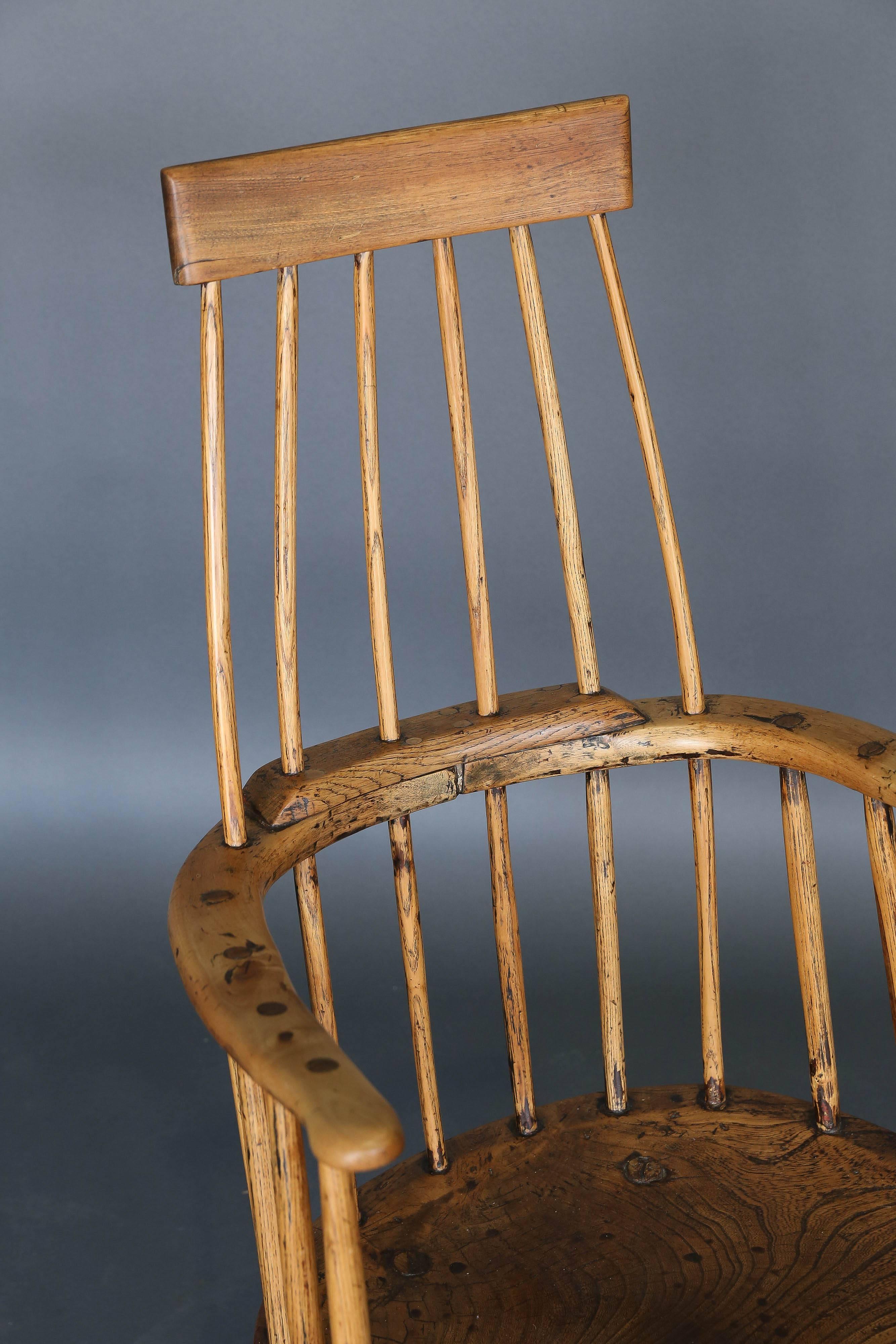 A Welsh Primitive comb-back stick chair. Very thick seat, handmade spindles. Elm and ash. Wonderful patina, excellent condition. Seat height is 13.5