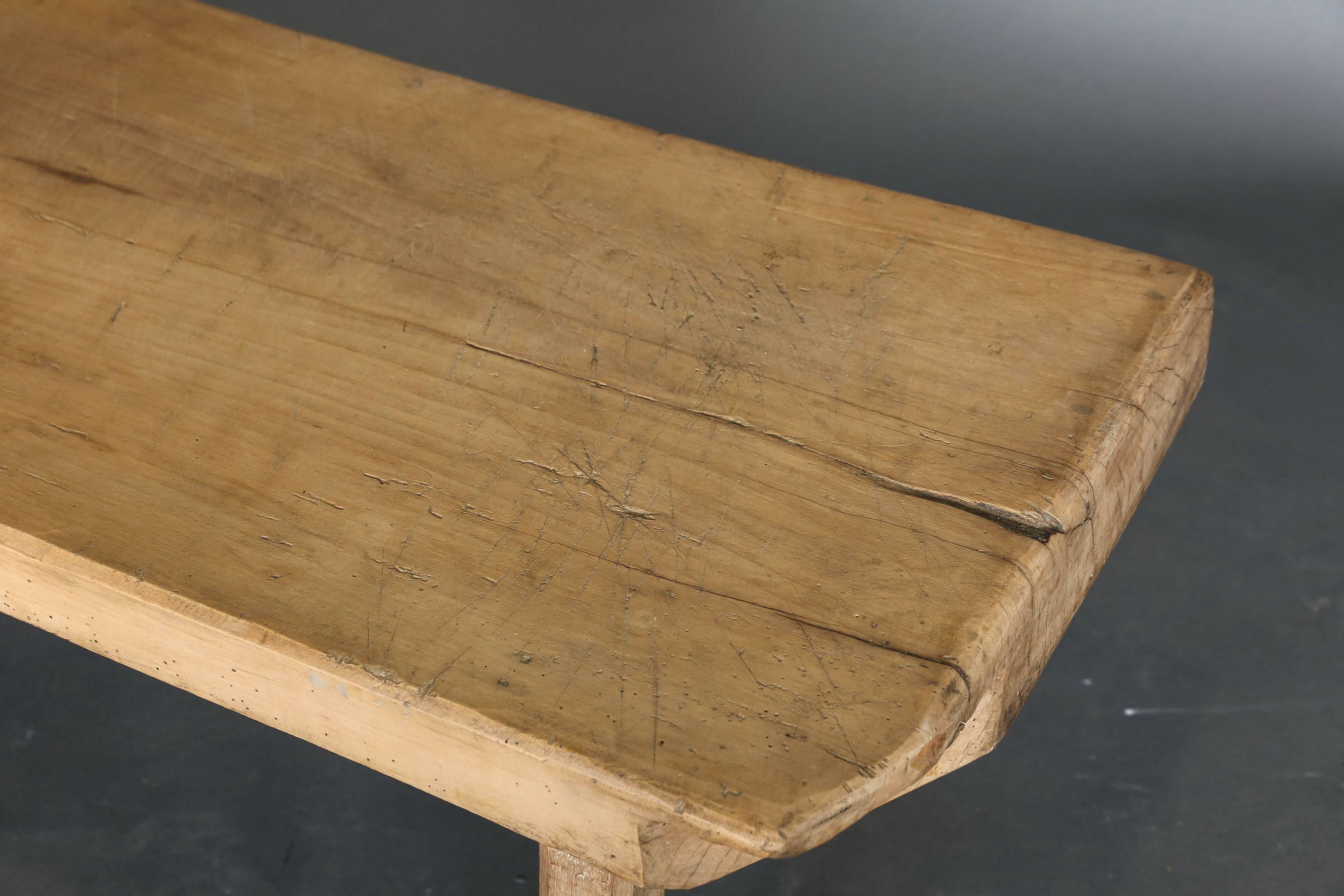 Antique Primitive 19th century elm single plank top bench or coffee table on four legs.