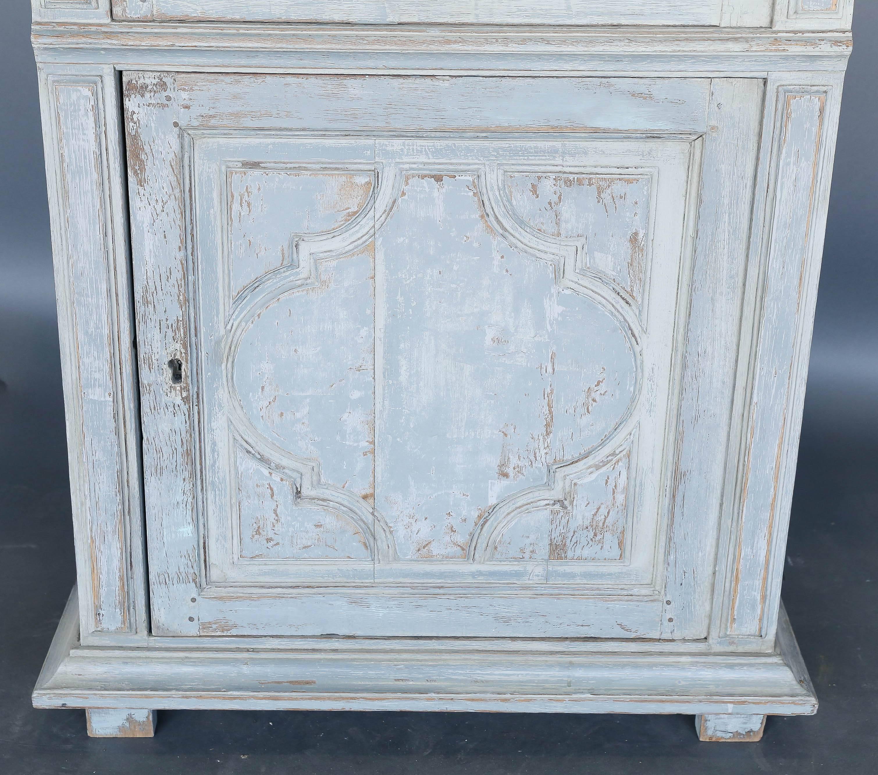 18th century painted Louis XV cabinet with original glass and three shelves. Beauty of this piece is that it is not very deep. The top has three shelves painted a darker blue/green turquoise and the bottom has a single shelf.