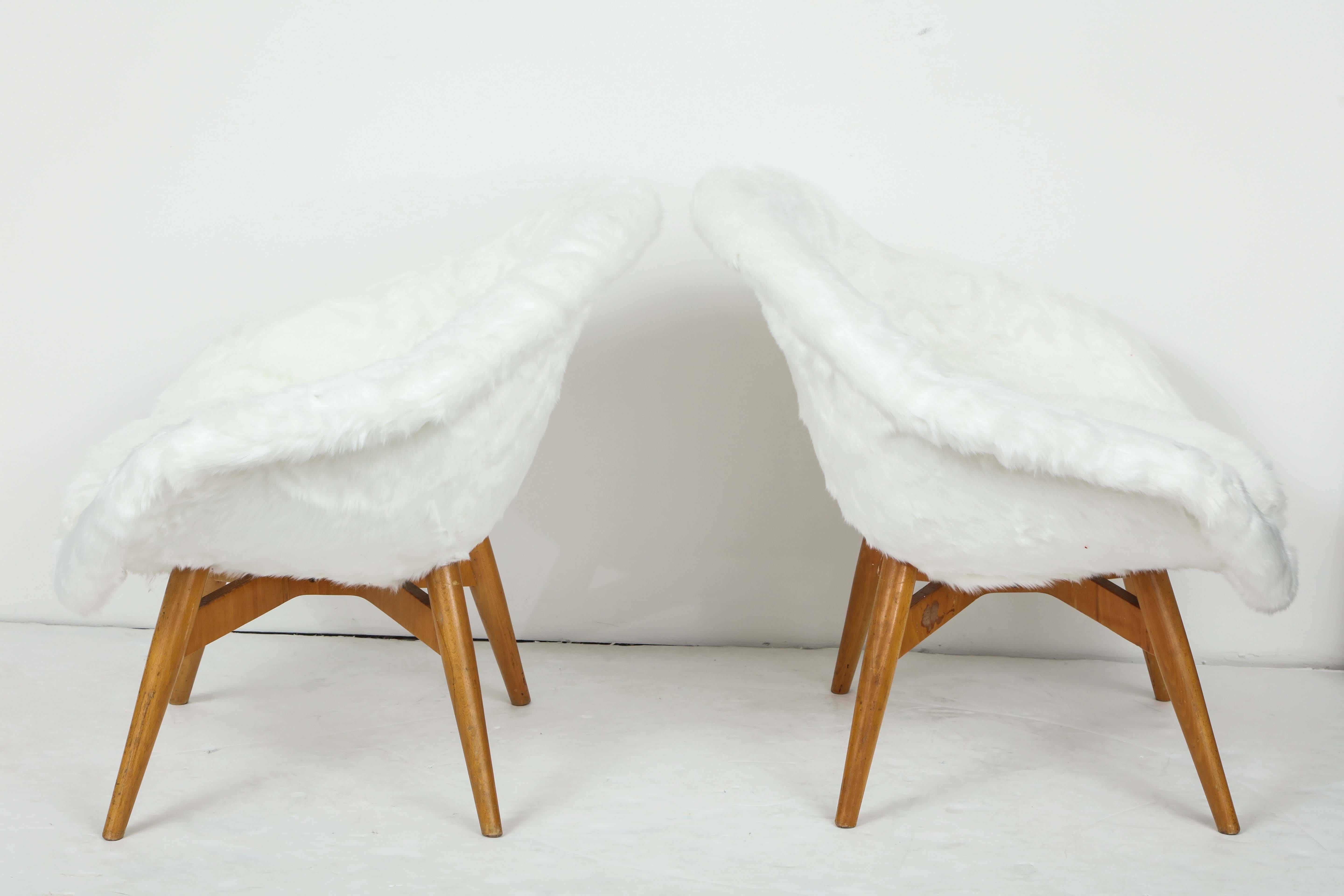 Mid-century chairs designed by Miroslav Navratil, a Czech designer in the 1960s.
The legs are in wood and the entire seat has been recovered with white faux fur