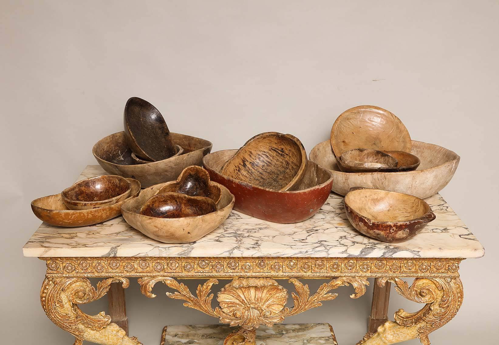 A stunning collection of 18th and early 19th century Swedish burl bowls in various shapes and sizes and with a variety of surfaces, some retaining original paint decoration, some with rich and lustrous waxed finishes, other dry and untouched, all of