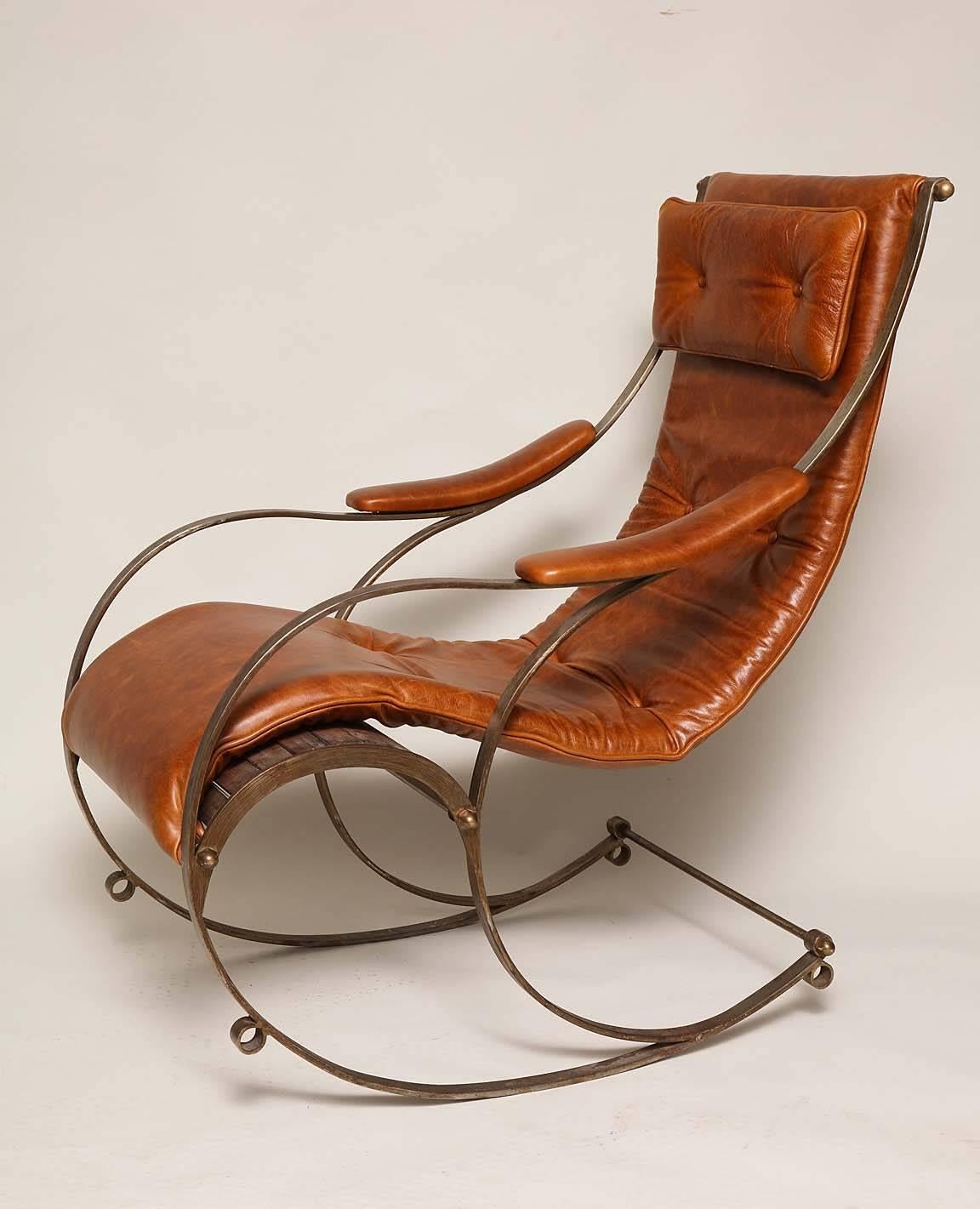 19th century steel leather and brass rocking chair by R. W. Winfield of Birmingham, of dynamic form, in padded leather upholstery over wood slatted frame, the whole a study of curvilinear design.

R. W. Winfield first exhibited this chair design