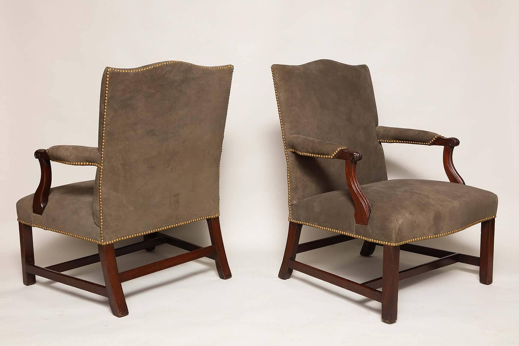 Good pair of Georgian style mahogany and suede Gainsborough chairs, the shaped back with gentle rake over upholstered arms with acanthus and bead carving, standing on square legs joined by flat stretchers, having good color and proportions and being