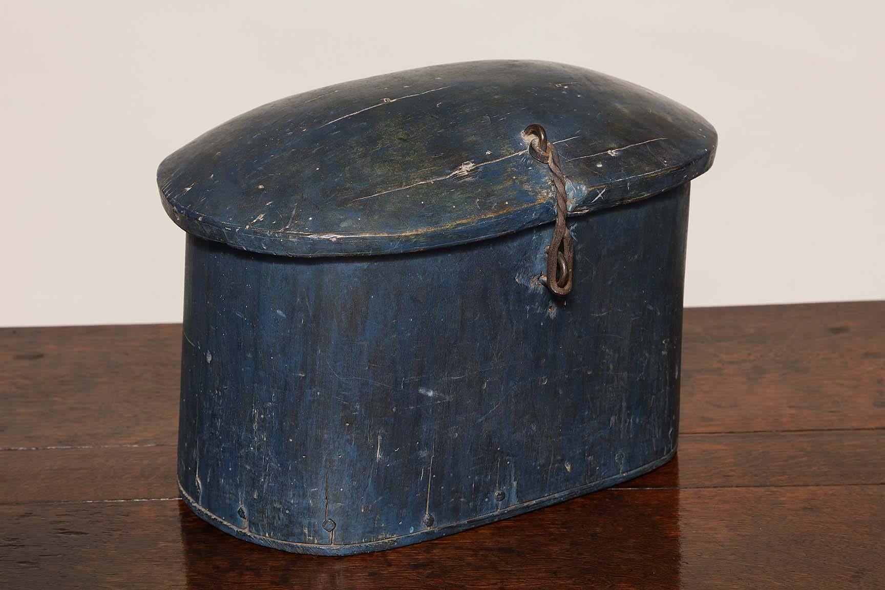 Good 18th century Norwegian dugout pantry box in beautiful original blue paint, the domed lid retaining original wrought iron strap hinges over oval body fashioned from a single hollowed out log, the base attached by pegs, the whole possessing good