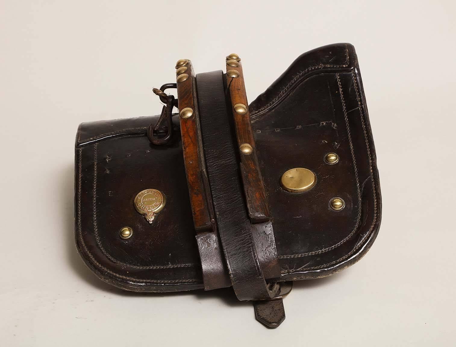 Unusual Irish 19th century specialty pony saddle with center harness by Rafferty of Dublin, in richly patinated leather, brass and timber and with padded ticking to the underside.