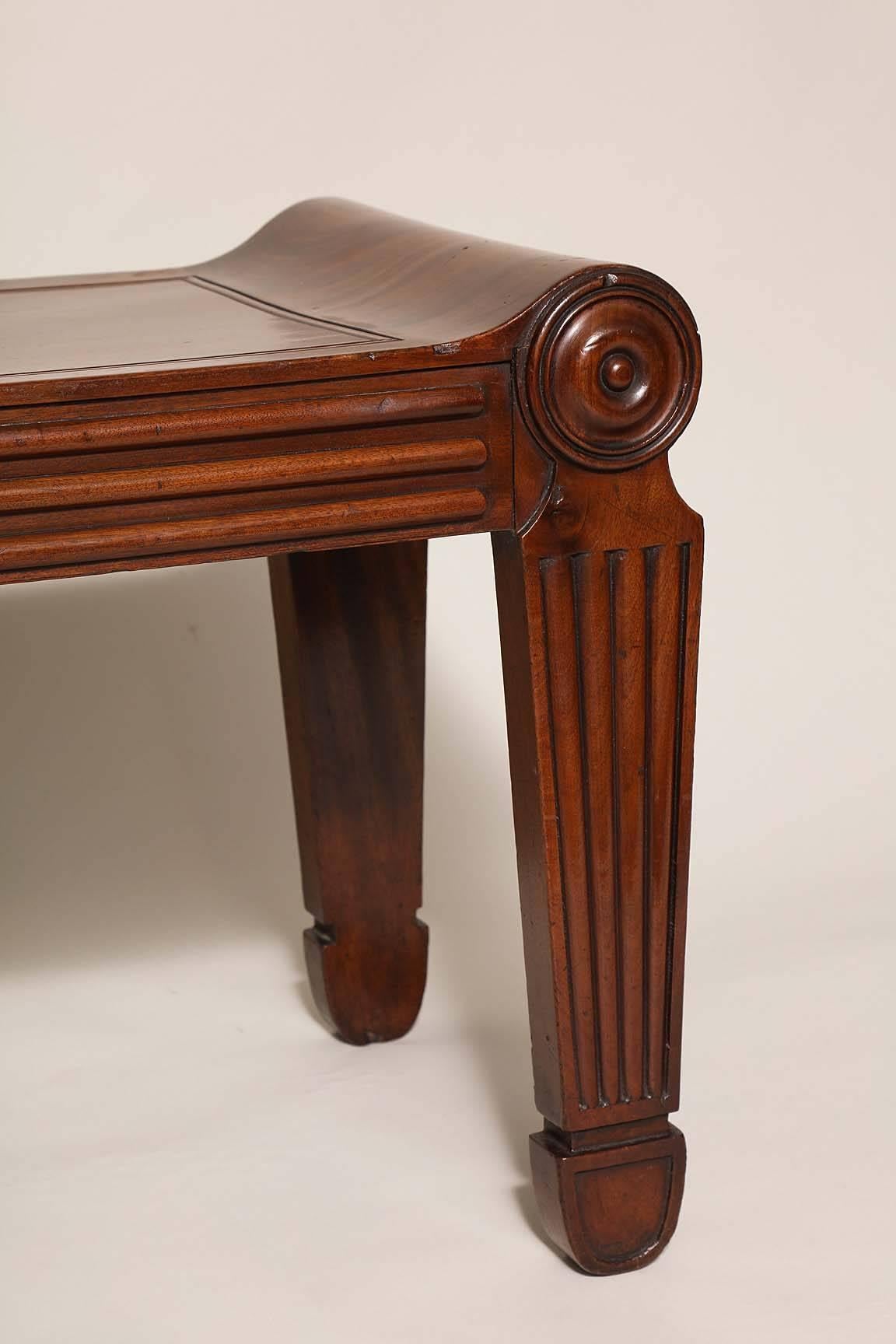 Very fine Regency period mahogany hall bench after a design by Charles Heathcote Tatham, seat with molded panel, the rolled ends over rib molded silhouette legs, the whole in well patinated and richly grained timber.

This design was based on an