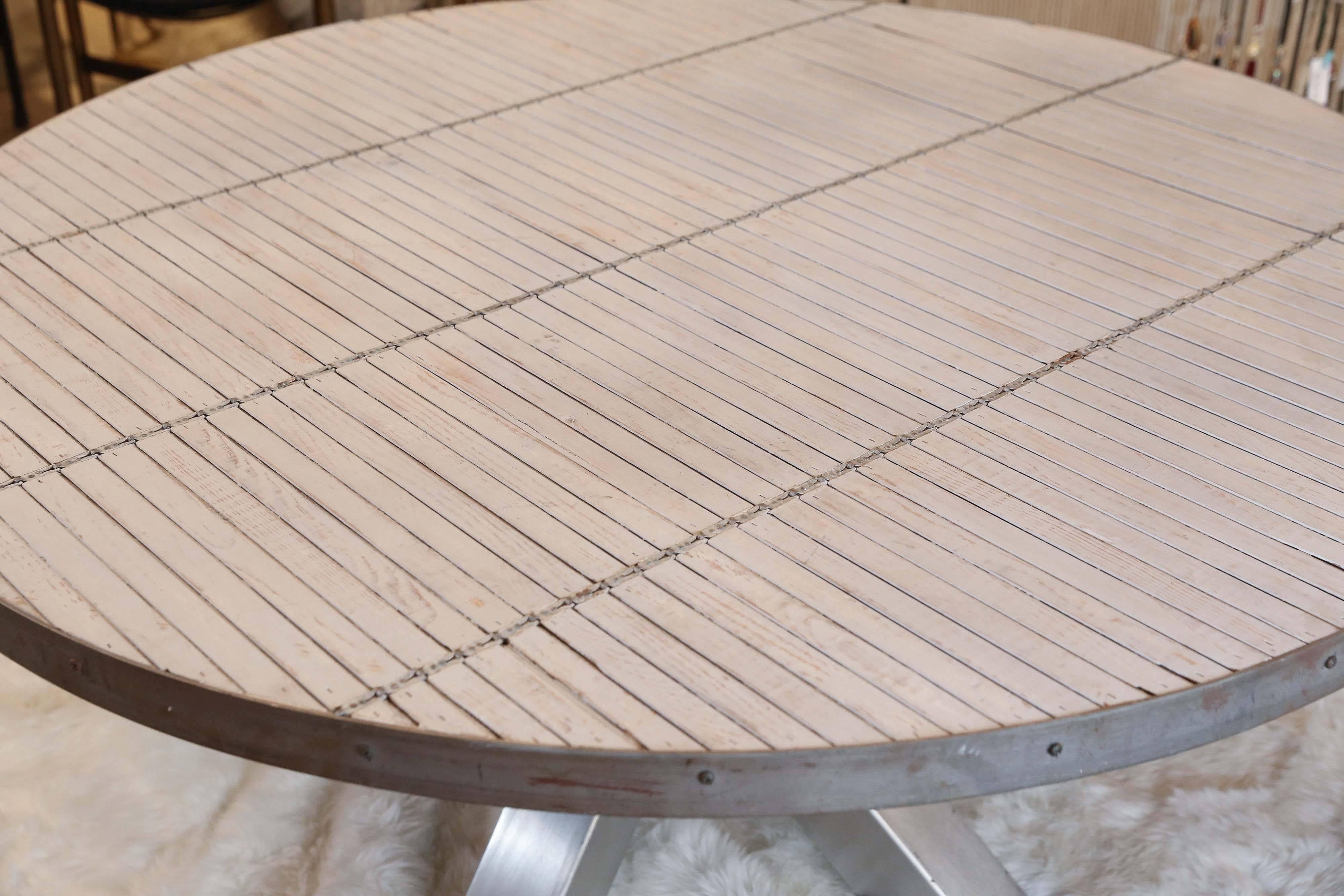 This table was crafted from repurposed materials and features a fantastic steel-clad base and a very unique top made with white washed vintage venetian wood blinds. The finish of the top is somewhat distressed, so please review the images closely.