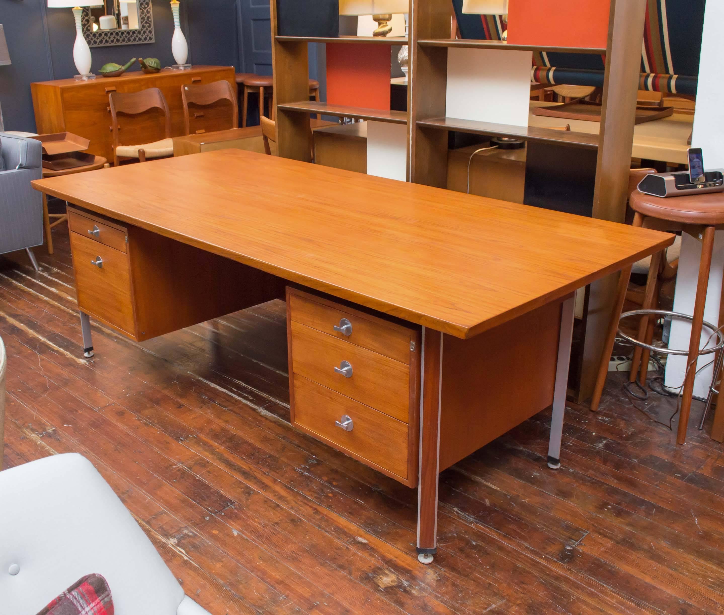Large and in charge executive size desk designed by Finn Juhl for France & Son, Denmark.
 Perfectly refinished teak with sculpted pulls on triangular adjustable legs.