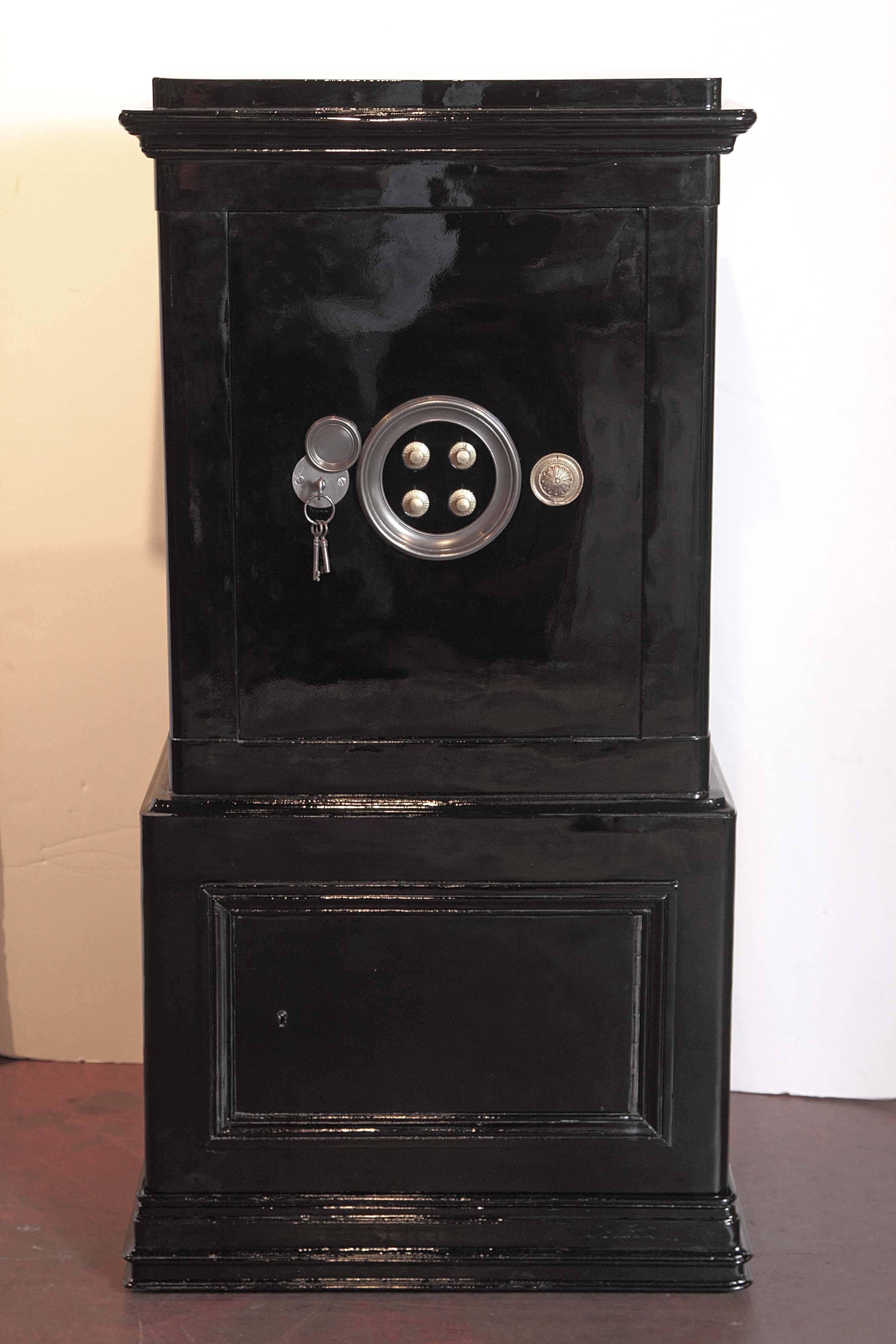 Keep your belongings secure with this large, antique safe from Paris. Crafted circa 1890, the safe has been completely repainted with a metallic black paint outside and an off-white paint inside. The safe has a beautiful, strong front door with