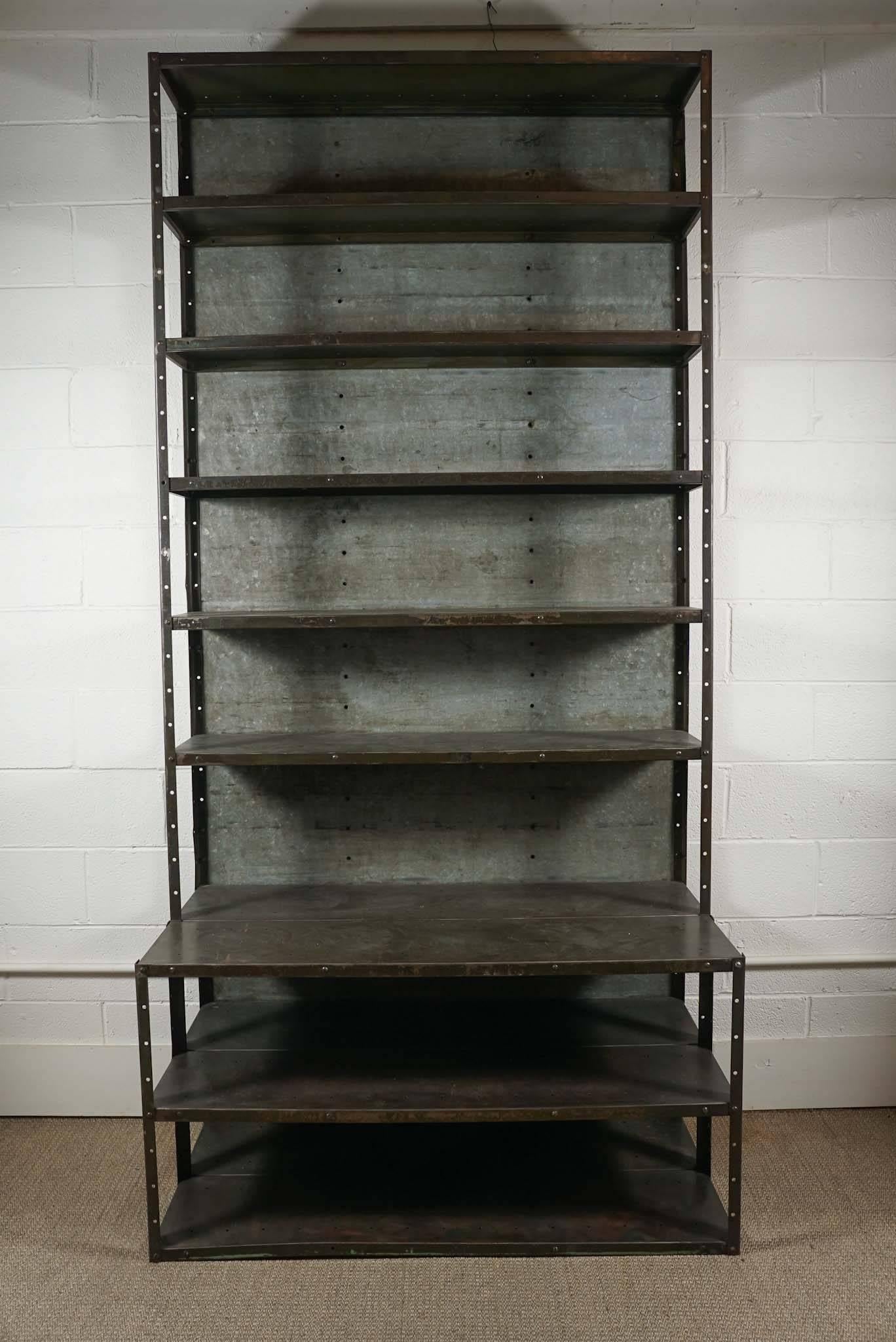 Here is a great Industrial tall gun metal bookcase with an extended base.
The top shelves are 12 inches high and the base is 24 inches deep.
The space between the shelves are 11 inches high. The overall height is 100 inches.