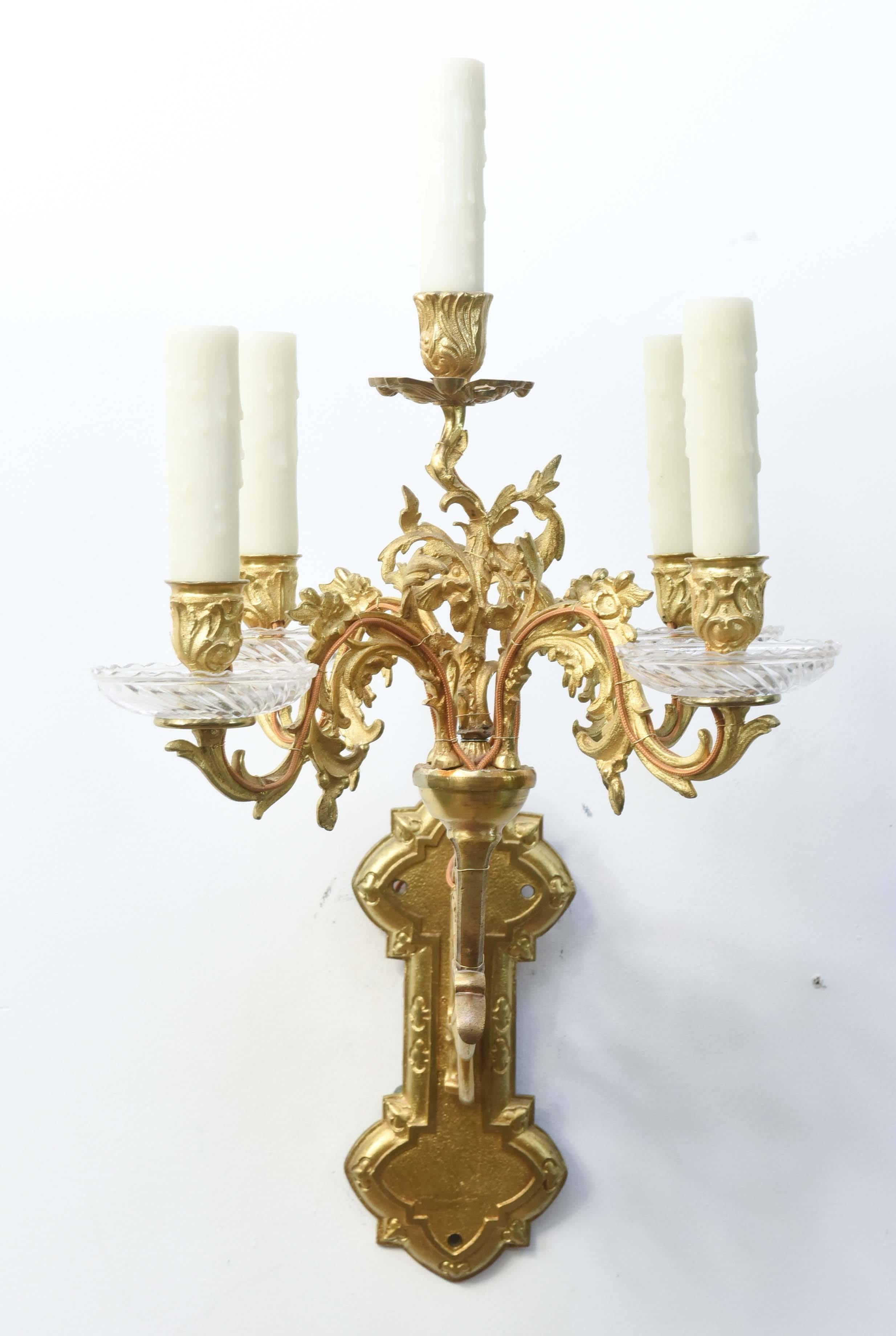 Candelabra style sconces with five lights. Originally candle. Ornate gilt bronze with glass candle cups. Matches a pair of single arm sconces, S110, posted separately.