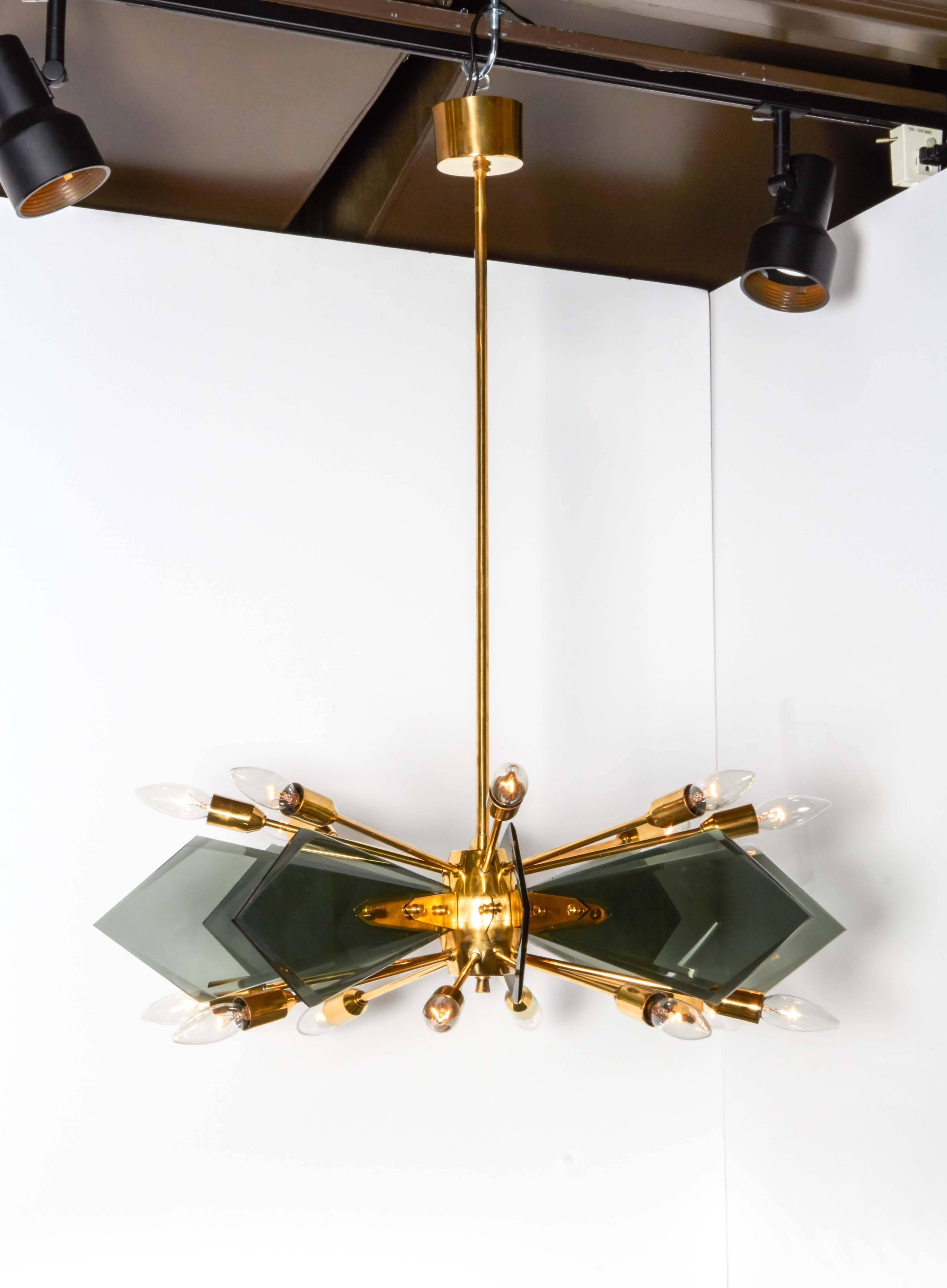 Exceptional Italian Mid-Century Modern sputnik light fixture. Comprised of a long stem brass frame with central orb and stylized fittings.  Features 16 Sputnik arms (eight on the top tier and eight on the lower tier), each fitted with an individual