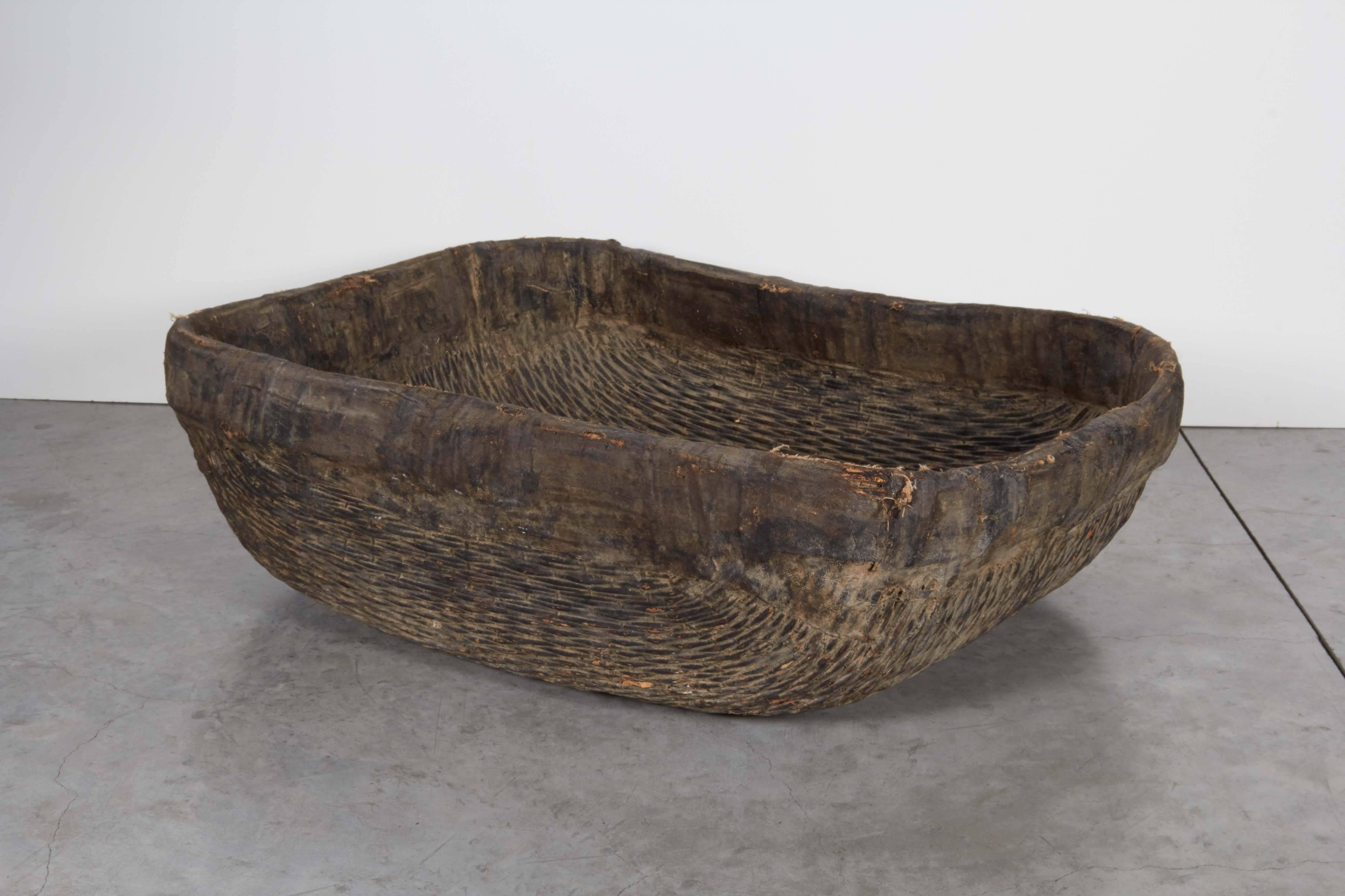 An unusual, large woven willow basket with fabric trim at the top displaying its many years of age in its beautifully worn and faded finish. From Shanxi province, circa 1900.
B445.
