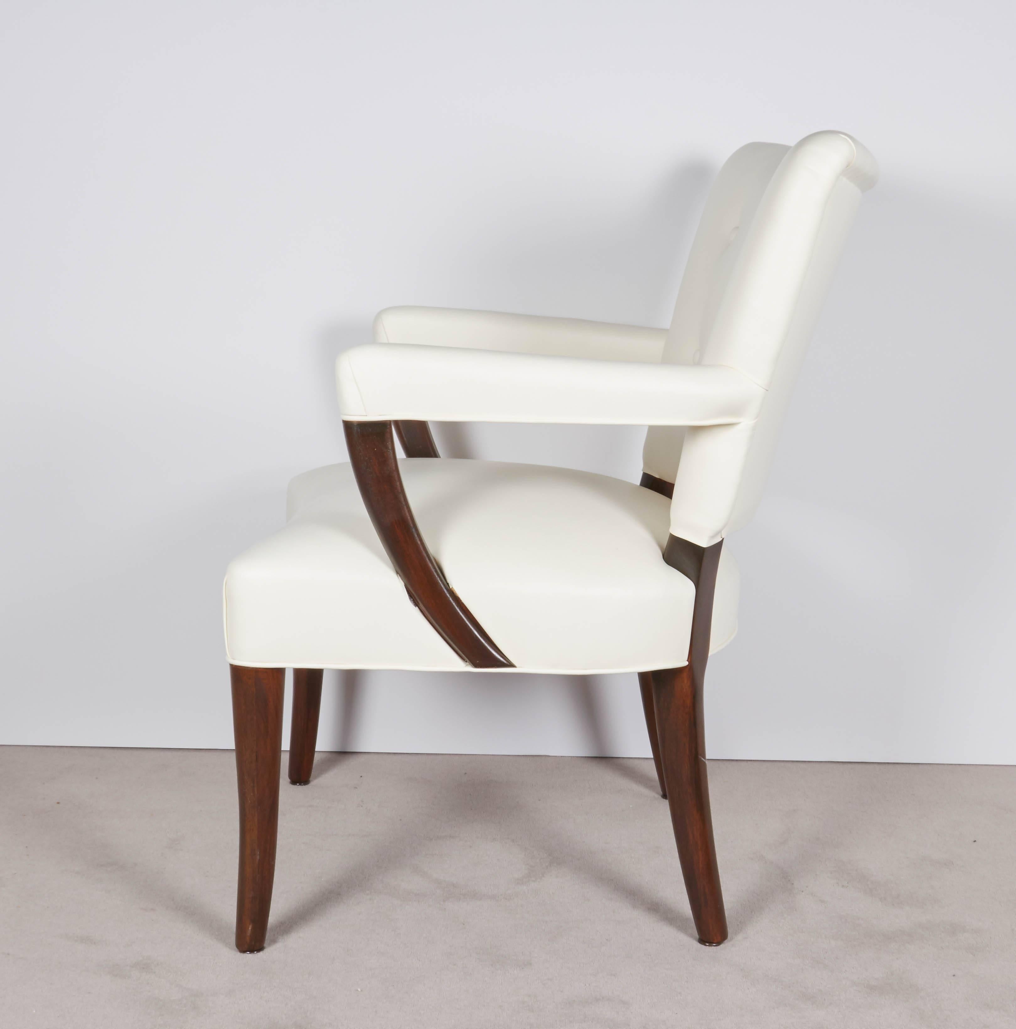 A substantial pair of game and armchairs, produced circa 1940s by the Stow-Davis Furniture Company of Grand Rapids, Michigan, following the style of designer Osvaldo Borsani, with tufted back, arm rests and seat upholstered in white leather, against