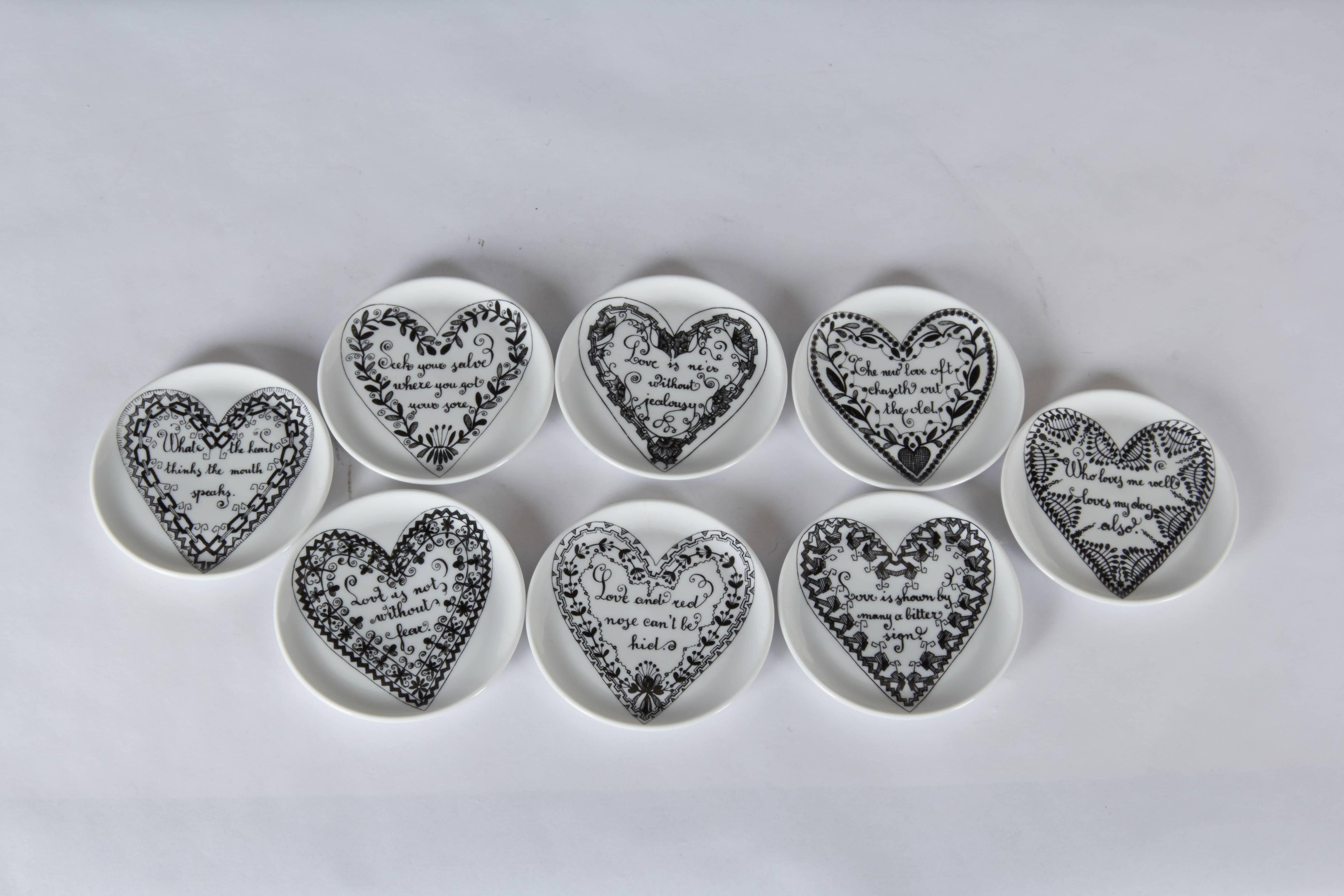 A rare set of eight porcelain coasters by Piero Fornasetti, produced in Italy, circa 1960s, decorated with individual proverbs and sayings on the nature of love; original box, measuring 3