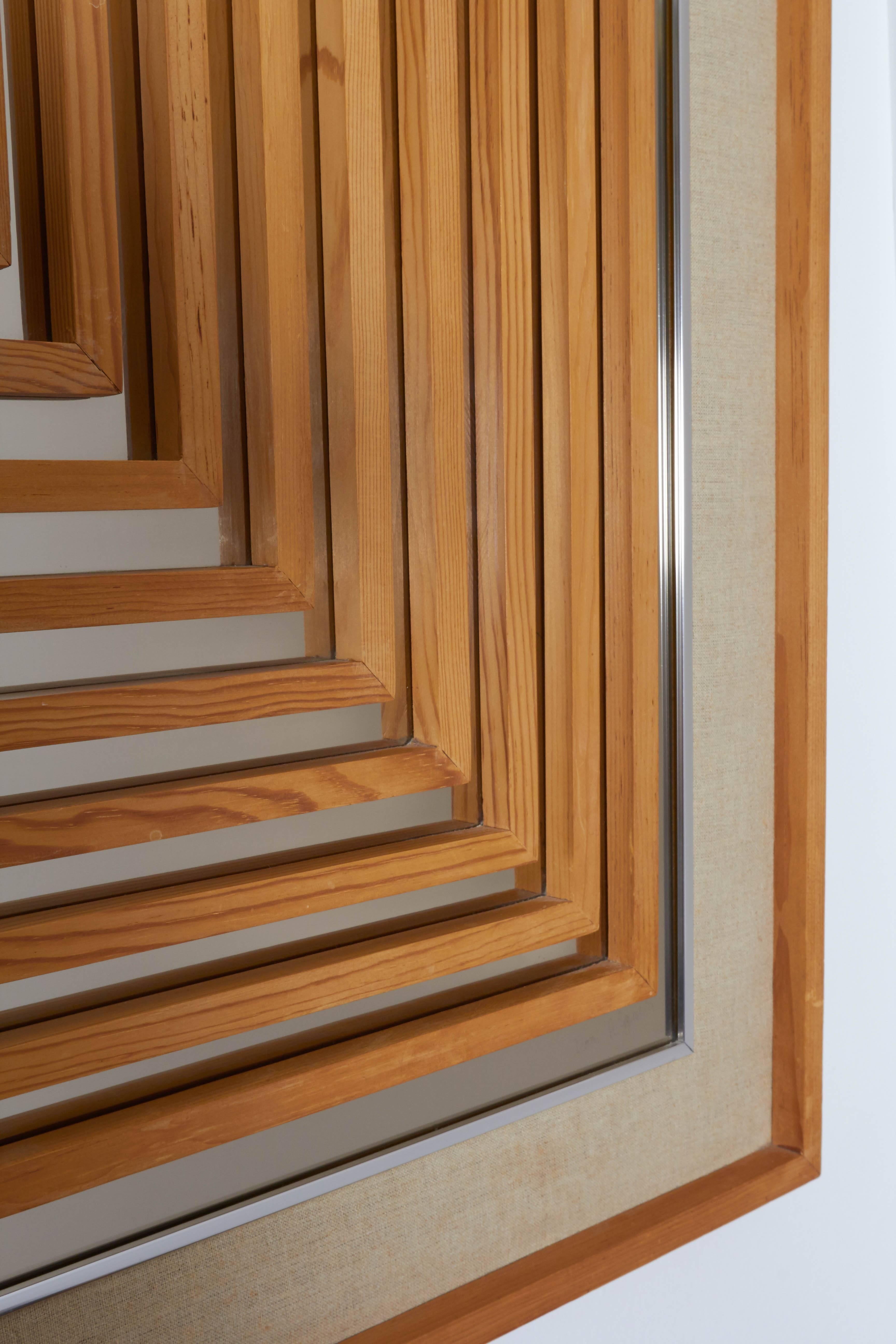 A unique 1970s Op Art style mirror, designed by Don Alguire for Greg Copeland, Inc., with wooden geometric details affixed to the reflective surface, mounted on fabric mat and wood frame. Markings include [Don Alguire] signed to the bottom right