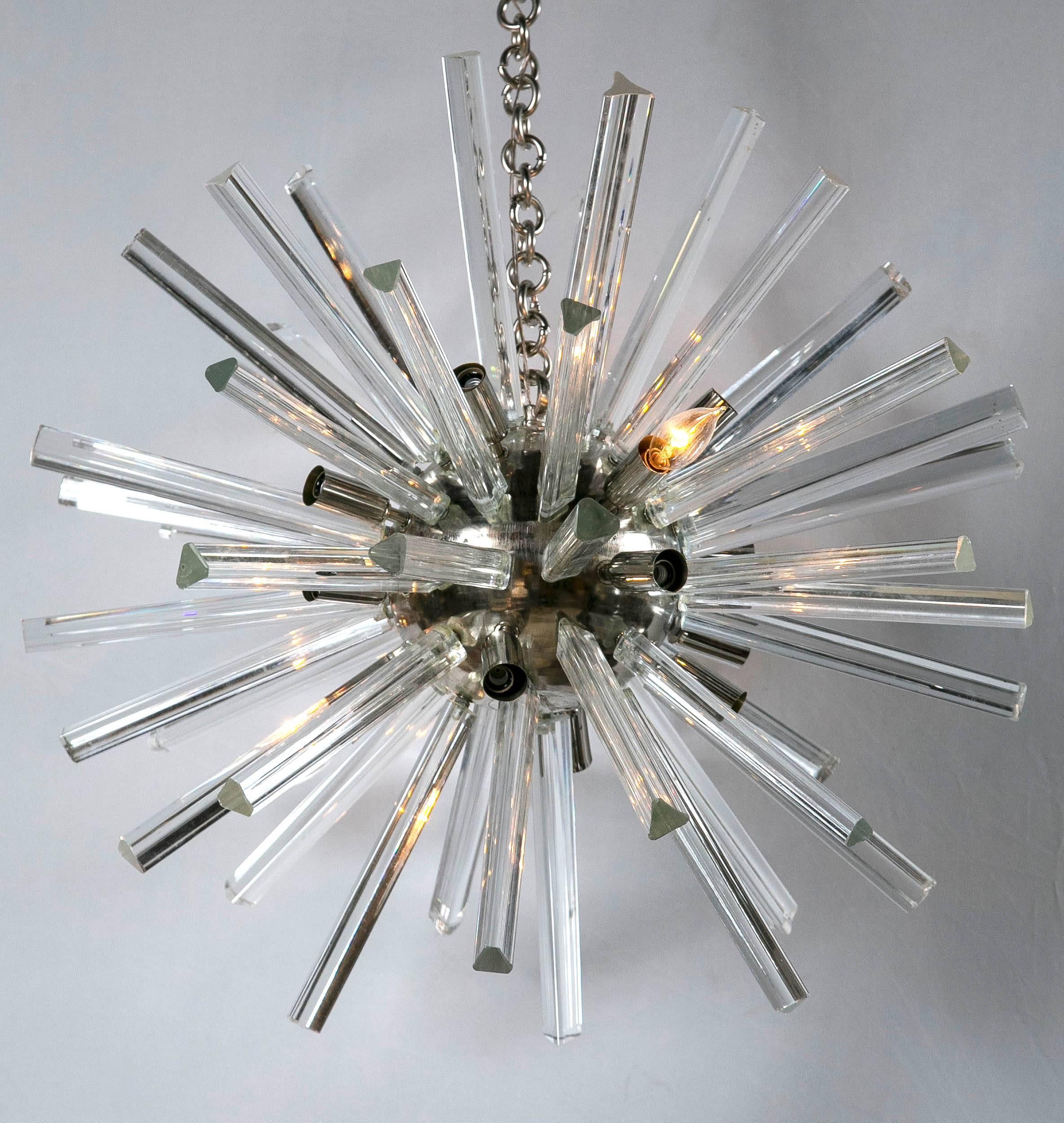 These Mid-Century Modern chrome spherically shaped centers have approx 48 crystals prisms flowing out from the center sphere to form a wonderfully decorative chandelier. The crystals are 10 inches long. The price is for one pair only. Matching