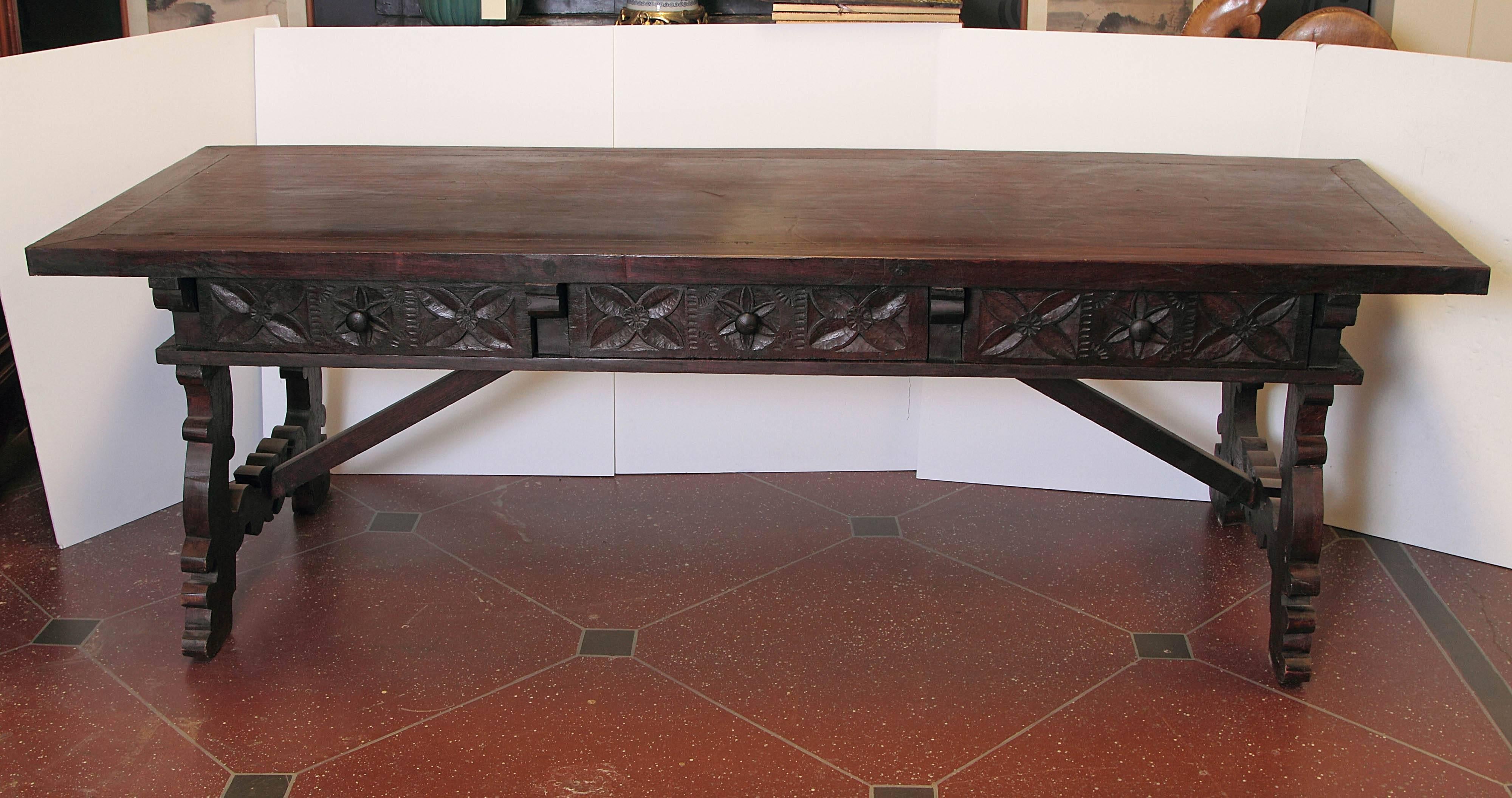 Spanish walnut trestle table with three drawers. Composed of 19th century elements and later.