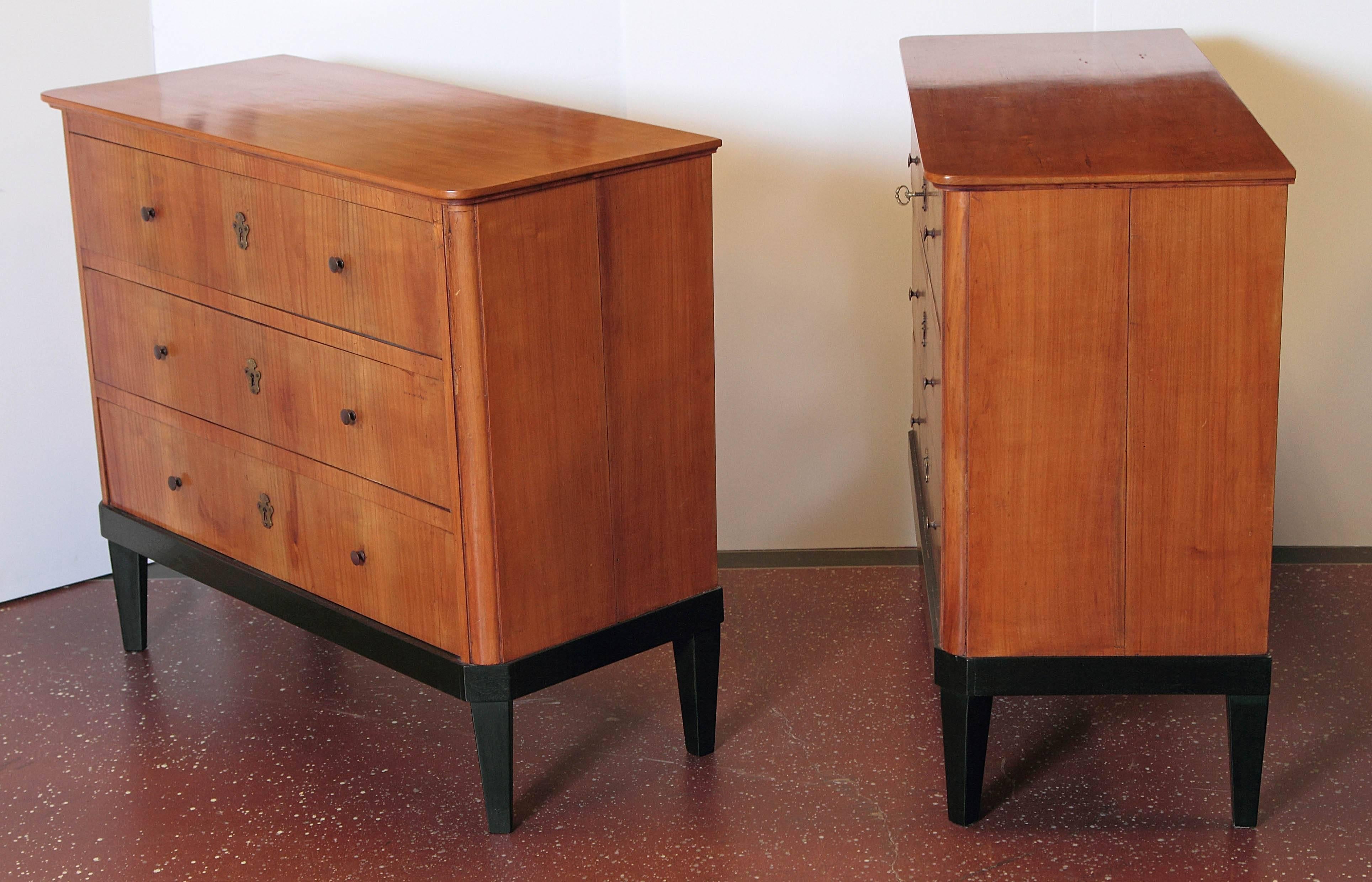 Pair of 19th century German Biedermeier walnut commodes. Ebonized bases.
