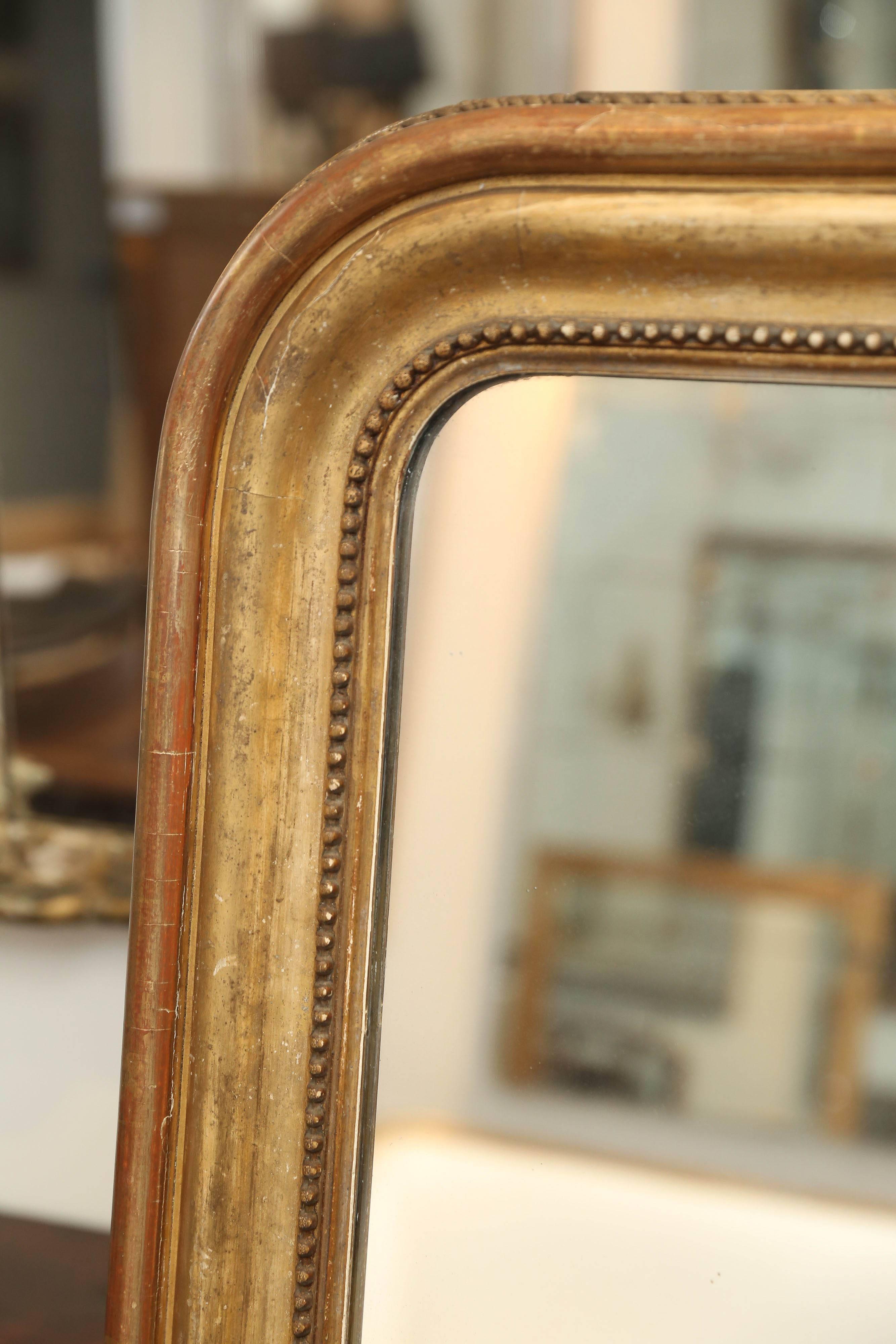 19th century Large Louis Philippe mirror with a 3/4 interior pearl detail and a frame with good wear on it.  Priced accordingly.