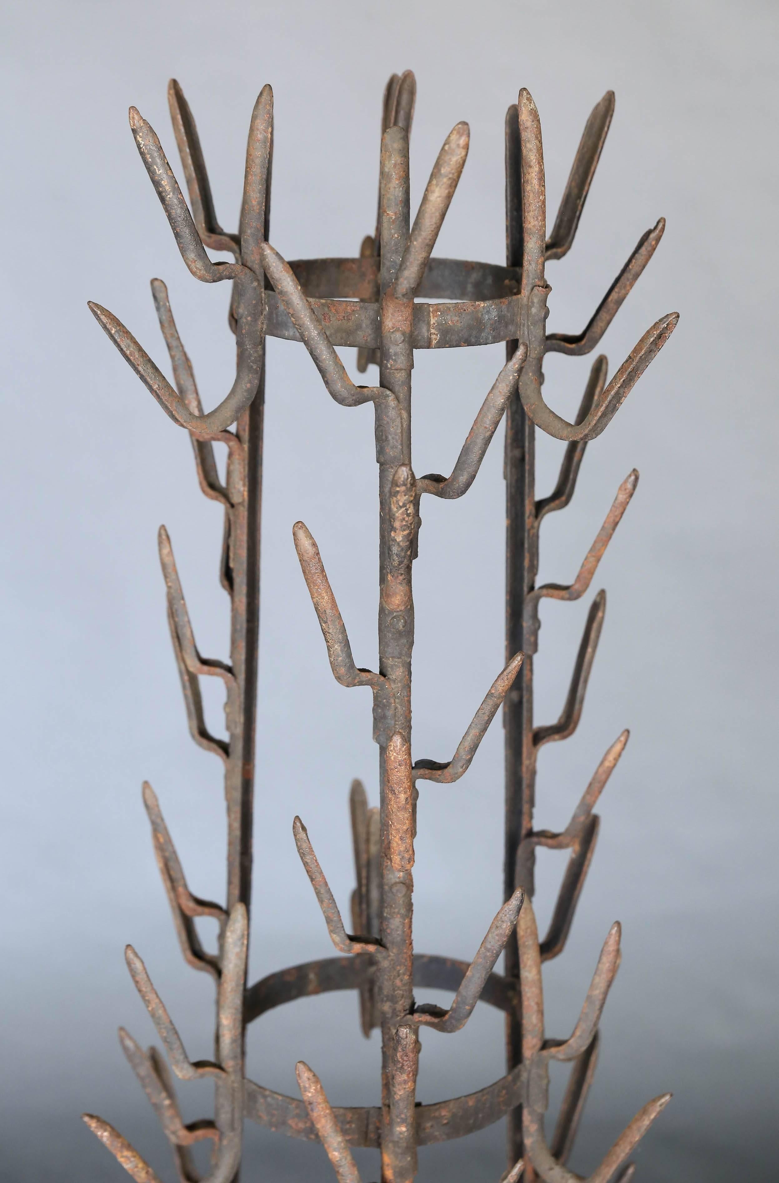19th century bottle dryer from Arras, France with stylized iron foot in the shape of an animal's paw. This piece is sculpture.