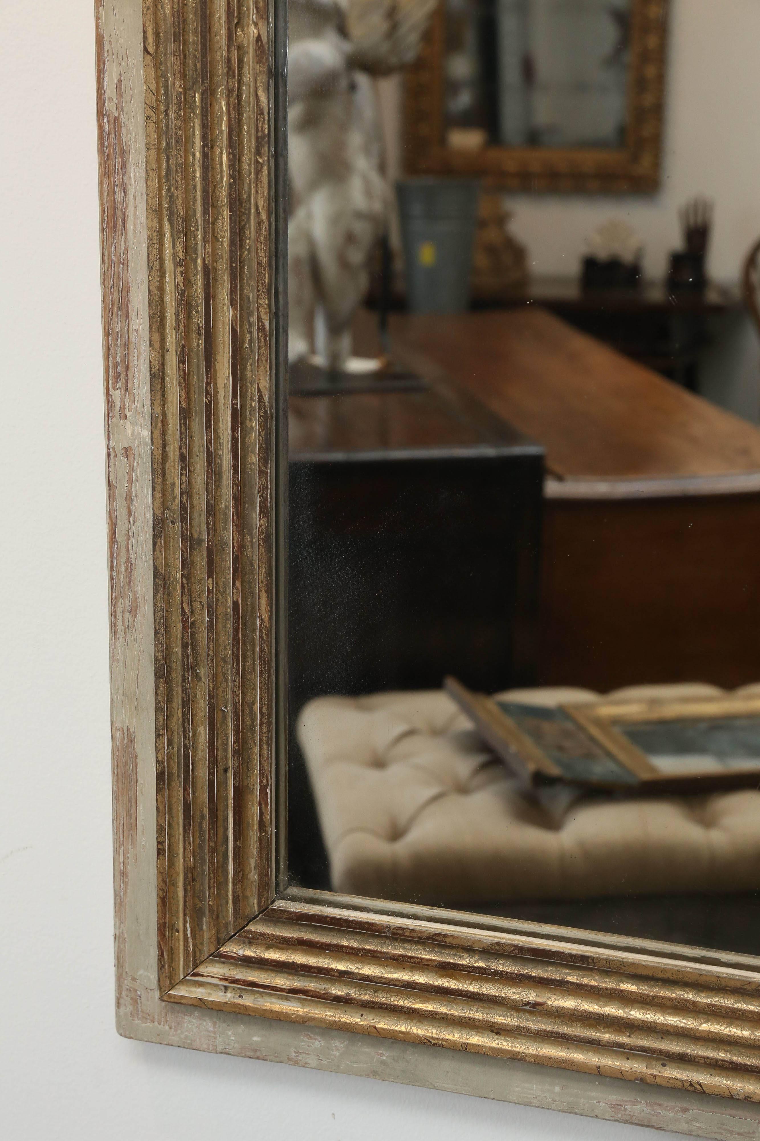 Pair of contemporary mirrors made from 18th century reeded fragments. Both made in the style of trumeaus with two sheets of mercury mirror glass in each one. These mirrors were made recently but with antique glass and wooden fragment details.