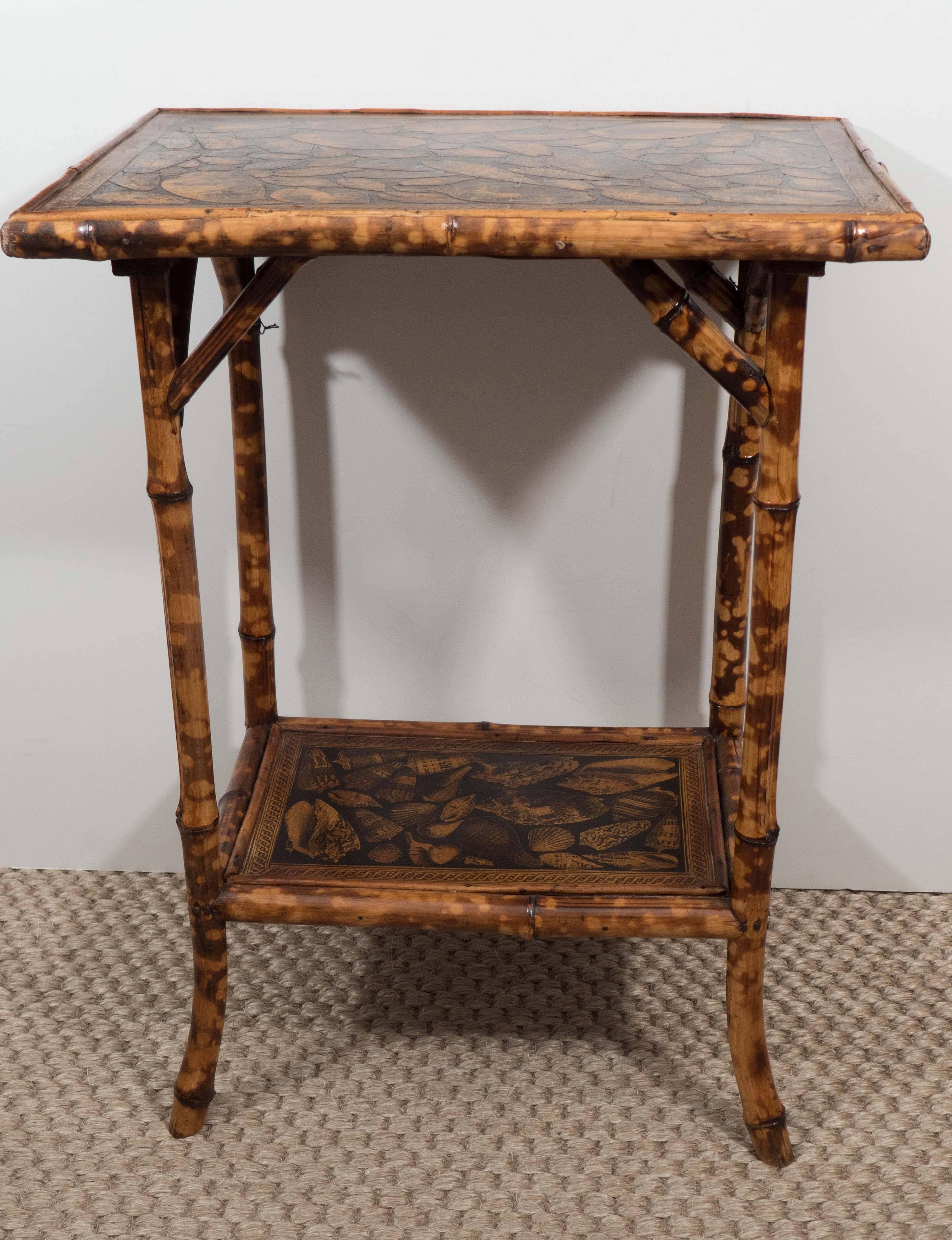 A charming 19th century two-tier rectangular table in beautiful bamboo with recent shell motif decoupage, French splayed feet and strut supports. A jewel of a piece!