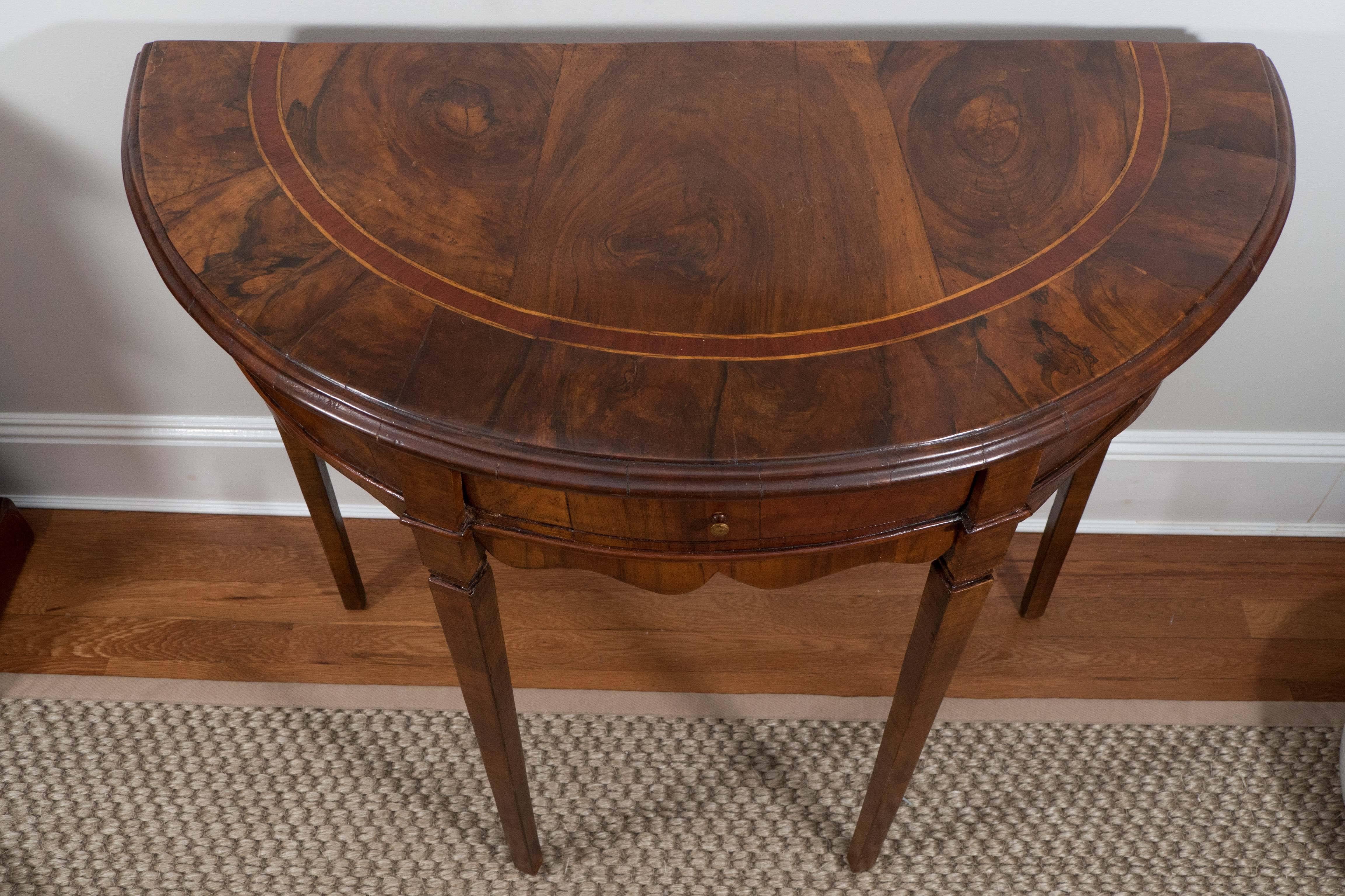 What makes this little table special are its fine details. The warm burled walnut finish, inlaid semi-circle design on top, the scalloped apron, and slightly tapered legs make this Italian table a little jewel that can be used as a side table, end