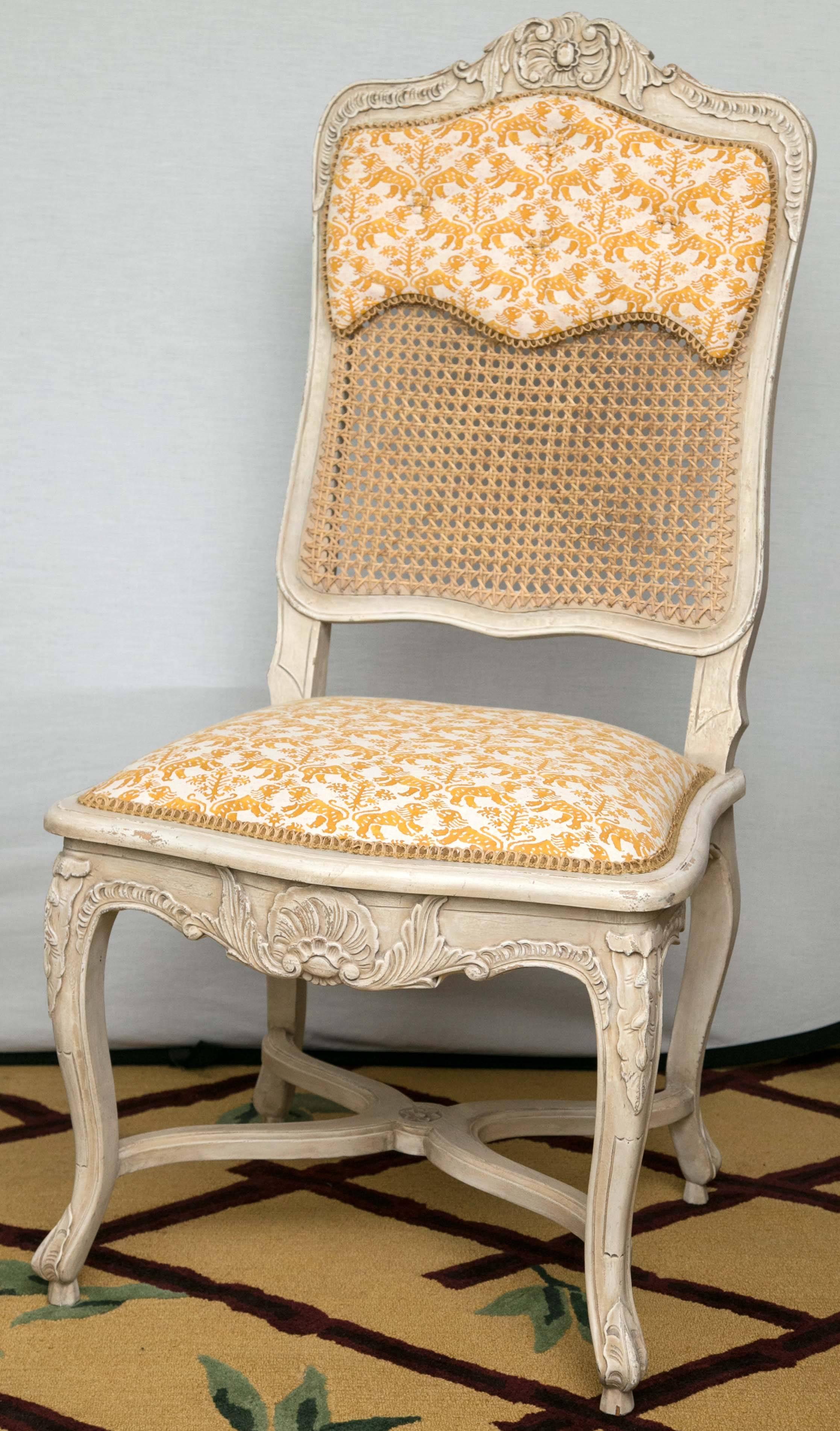 Set of 12 Maison Jansen Style Cote, France, Fortuny fabric, Regency style chairs. Hand-carved, exquisite fabric. A Buttercup Yellow Fabric with Dragons in White Adorn the Seats and a .25 of the Seat Backs - The Seat Backs are Caned - white and the
