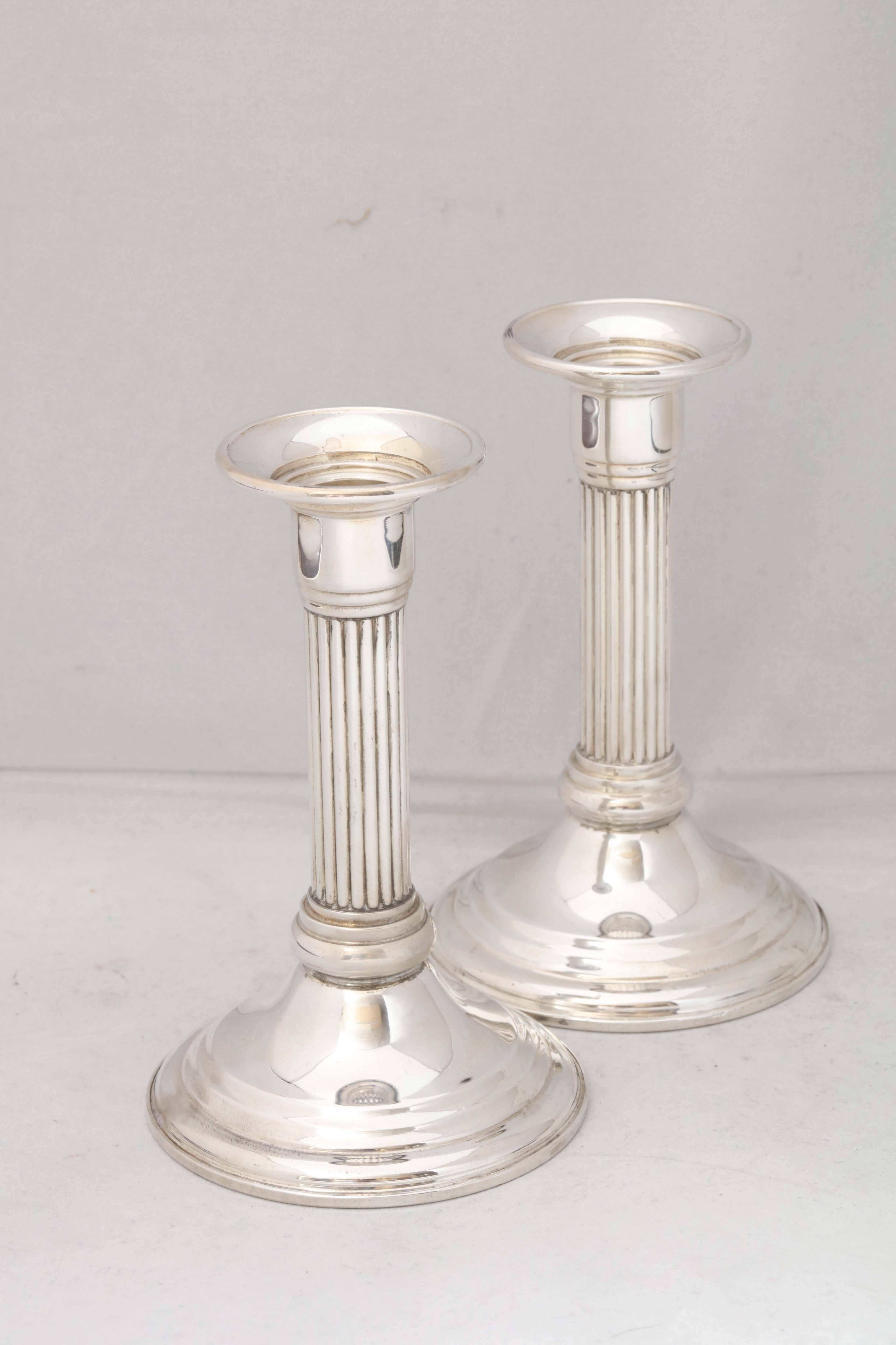 Pair of sterling silver, neoclassical candlesticks with 