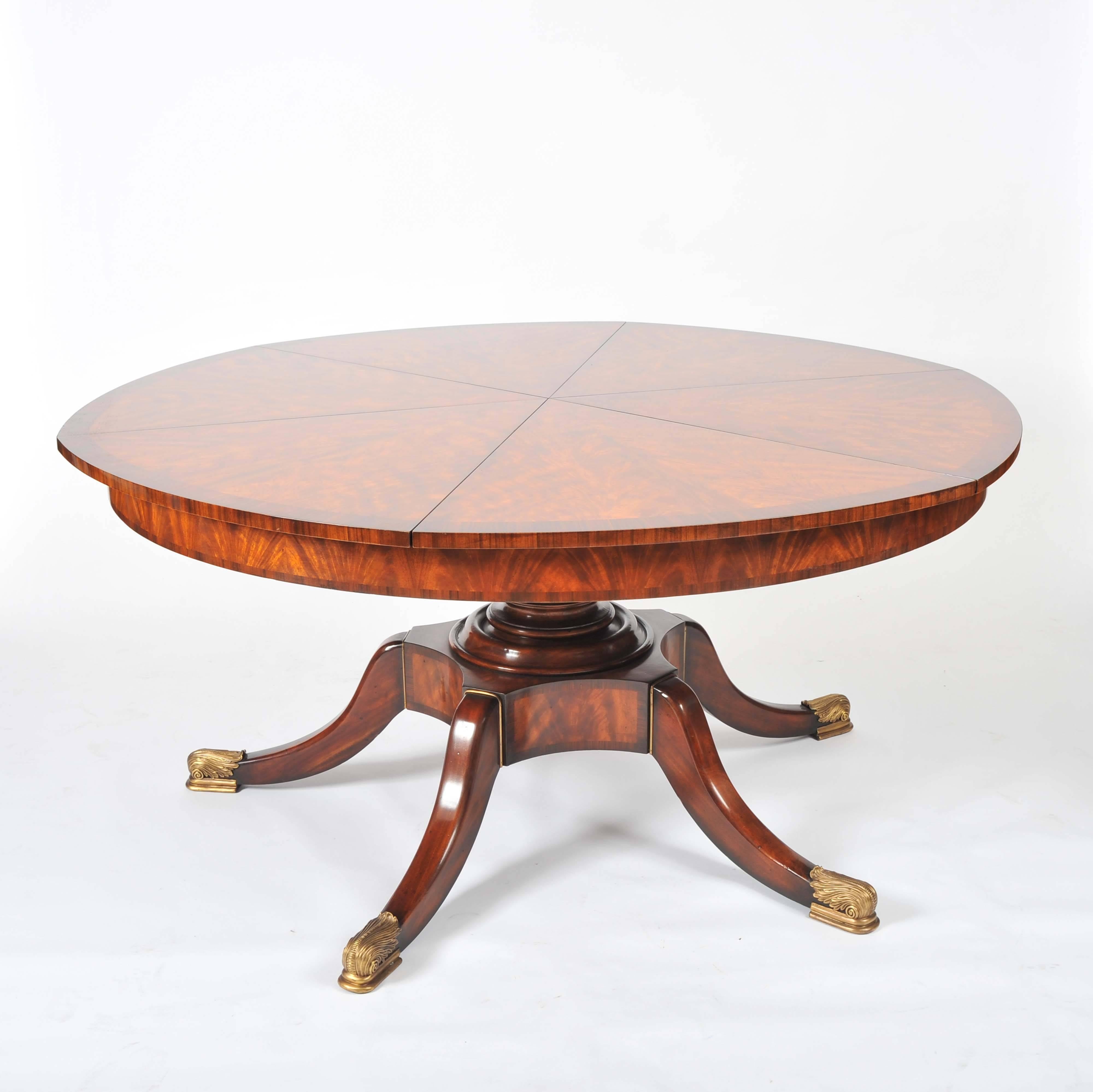 This stunning and beautifully designed flame mahogany segmented circular extending table is in the Regency style, and features leaves that are internally stored. The table comfortably seats six, and extends to seat eight to 10. The table rests on a