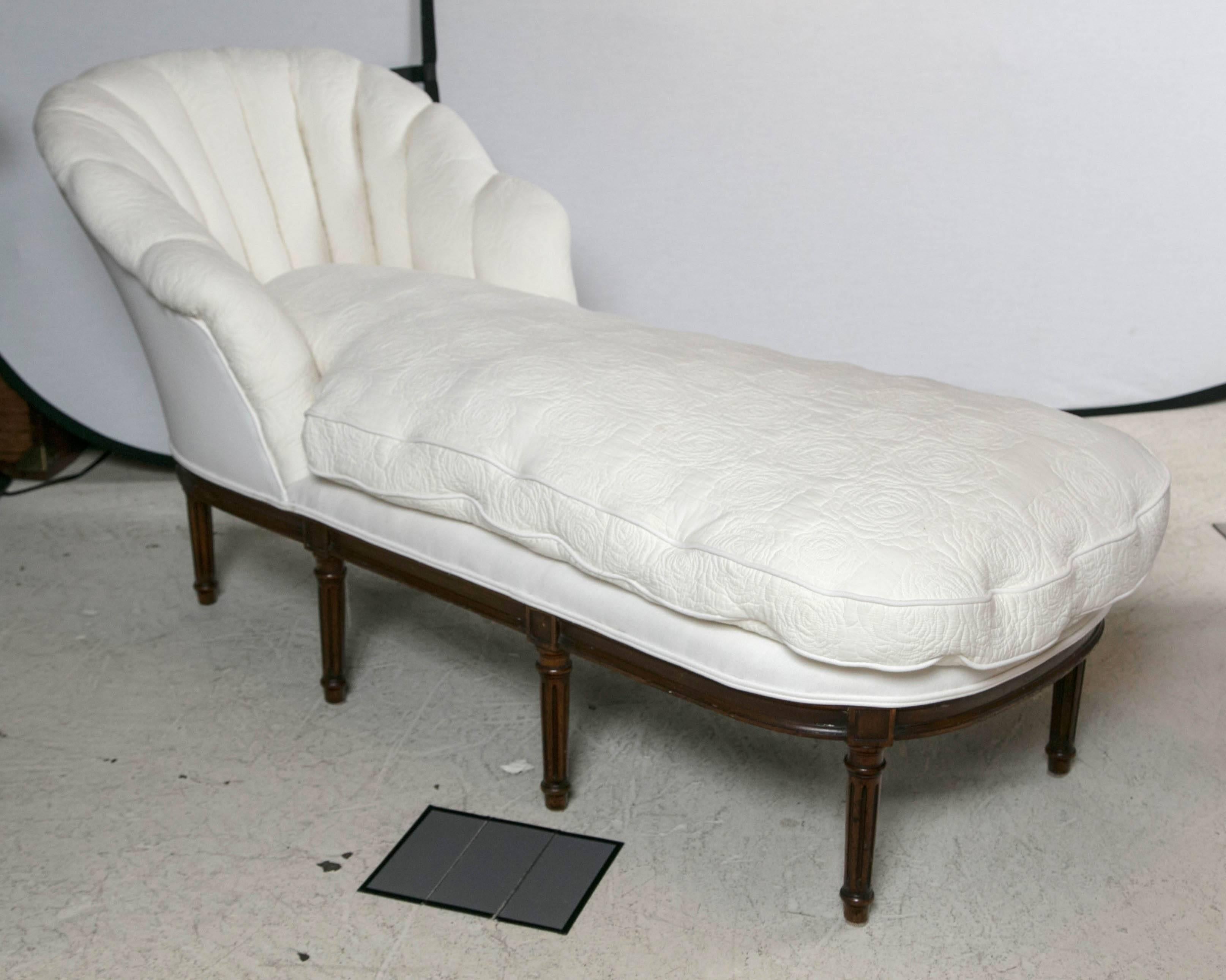 A 19th century French chaise longue. Down filled and newly reupholstered in white linen and antique white on white stitched floral quilt fabric. Fan shaped back.