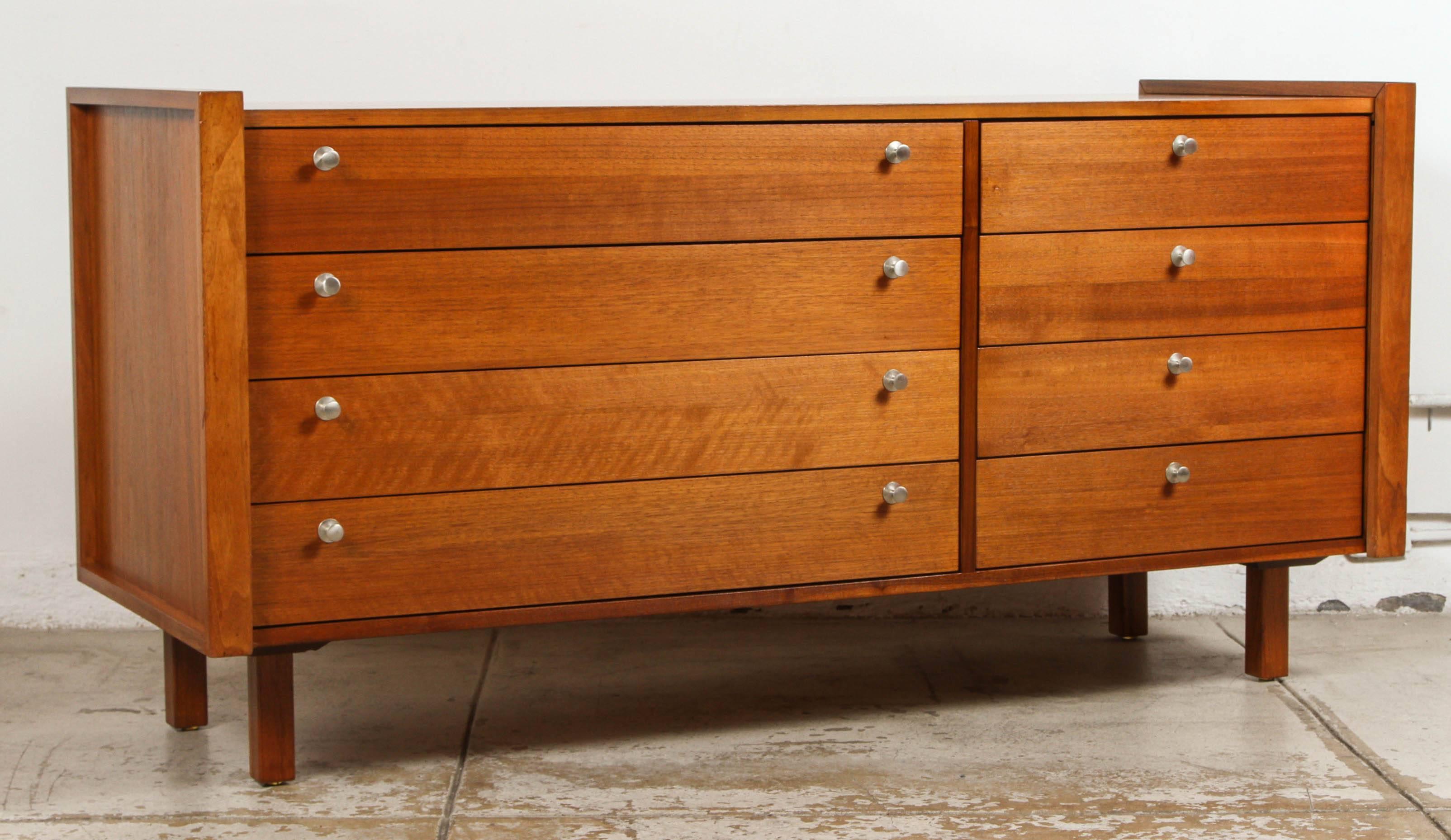 Beautiful condition on this walnut dresser by Martin Borenstein for Brown Saltman. Two sets of four drawers all functioning perfectly with original hardware. Original factory tag intact on back (see image).
