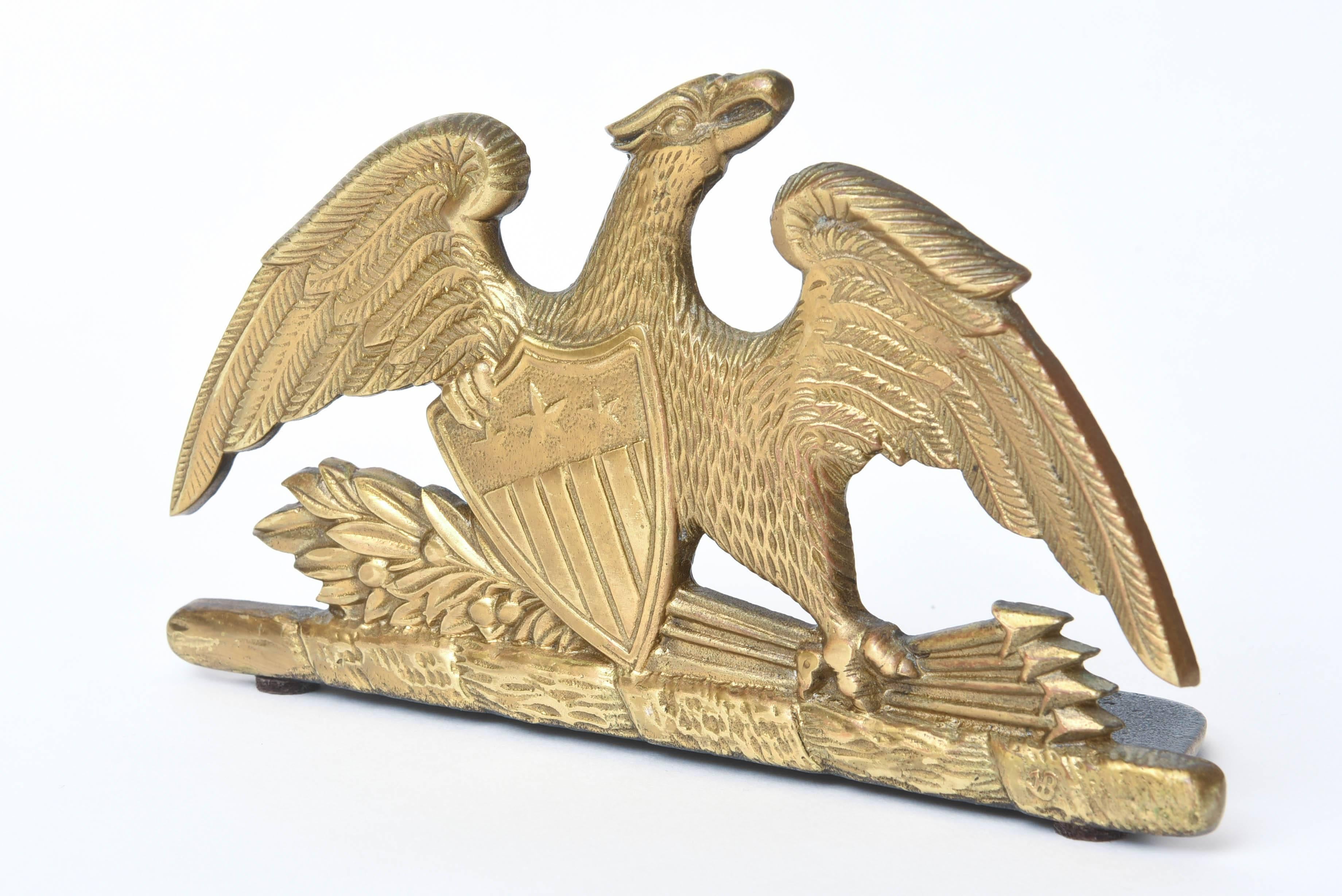 A fine and Classic pair of bookends featuring our nation's emblem of a majestic eagle clutching an olive branch and arrows. Signed and hallmarked 1952 VA Metal Crafters. This pair is in great vintage condition.