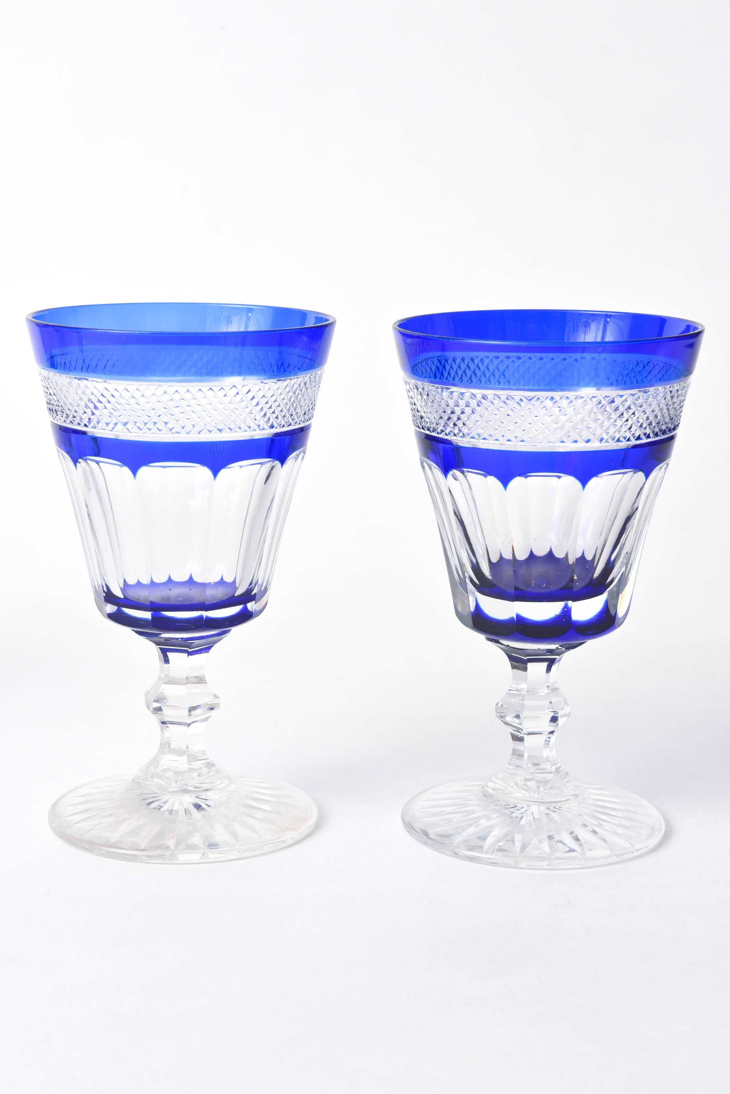 A charming group of wine glasses with cobalt blue glass blown and cased onto the clear and cut into a Classic style pattern. Comprising 12 glasses in total: nine of one pattern and three in another. We love the elongated thumbprint and cross hatched