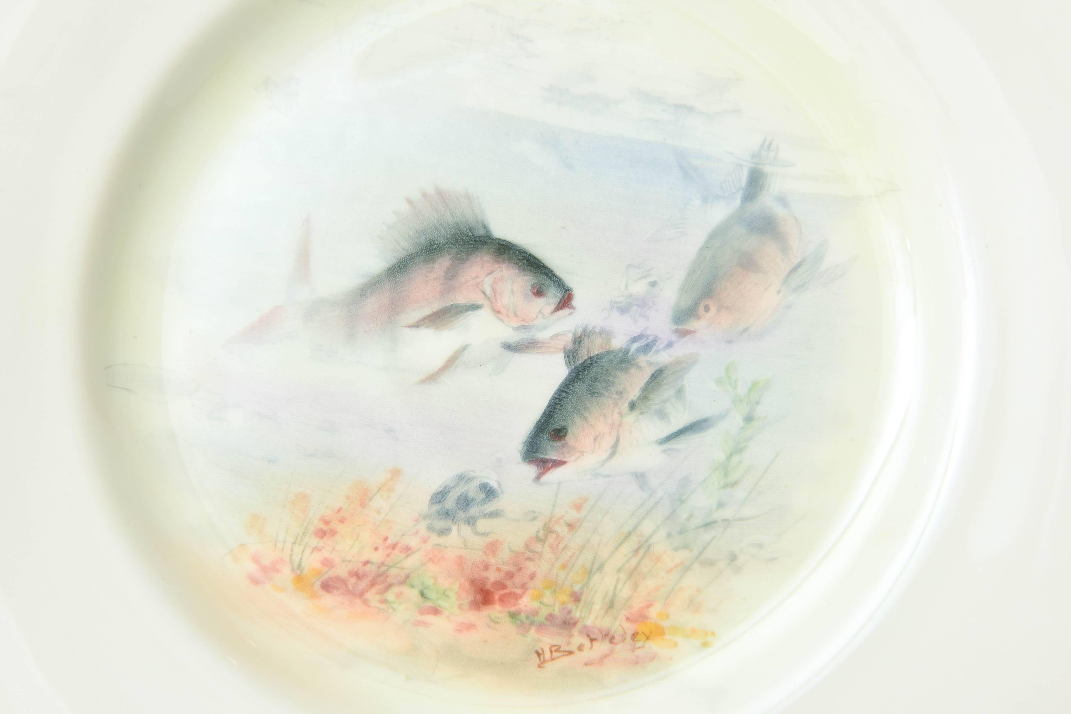 A Classic and elegant fish service consisting of 12 artistically painted fish in their full flora and fauna ground. Trimmed in 24-karat gold and perfect for display, lunch, or fish course. Each bearing the signature of Royal Doulton's premier artist