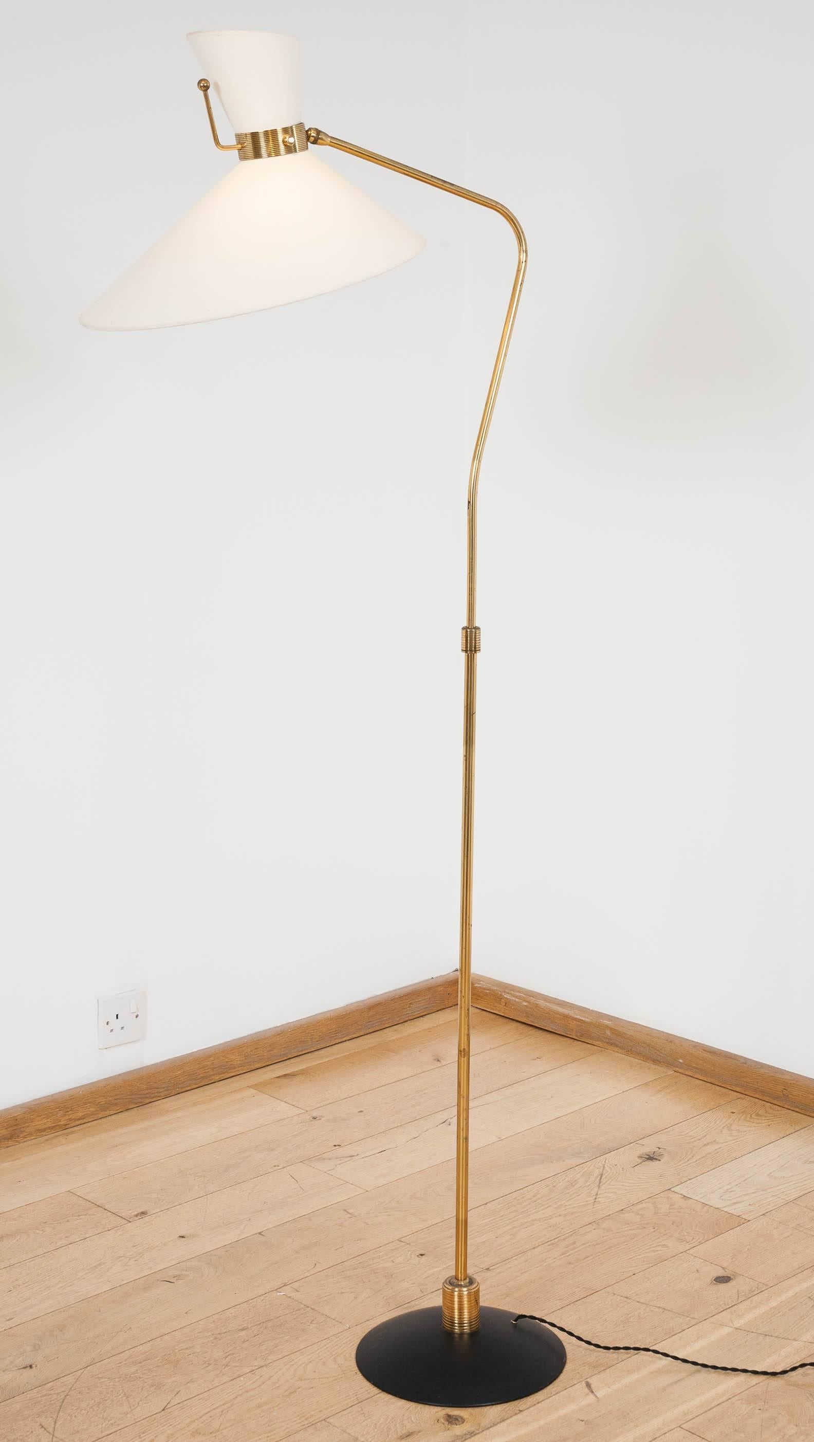 Telescoping brass floor light with gently angled shaft supporting pivoting shade with up and down lights, on black metal foot. Replacement shade.
Max height: 180 cm.
 
