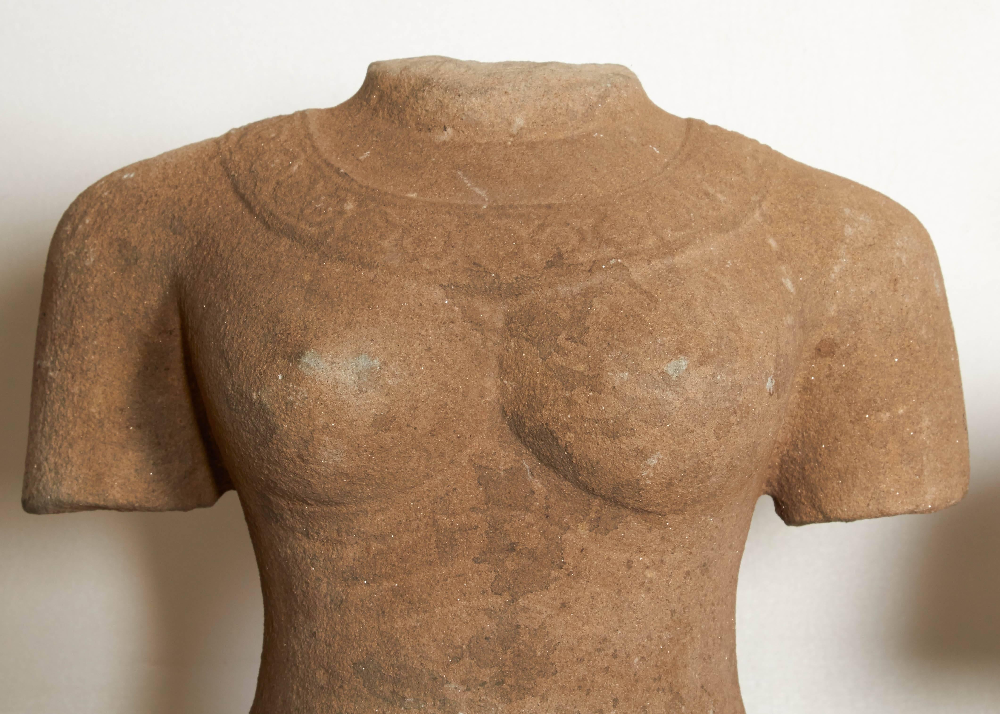 A pair of carved sandstone torsos, male and female, on stands. Sold separately. Dimensions of tallest shown below.