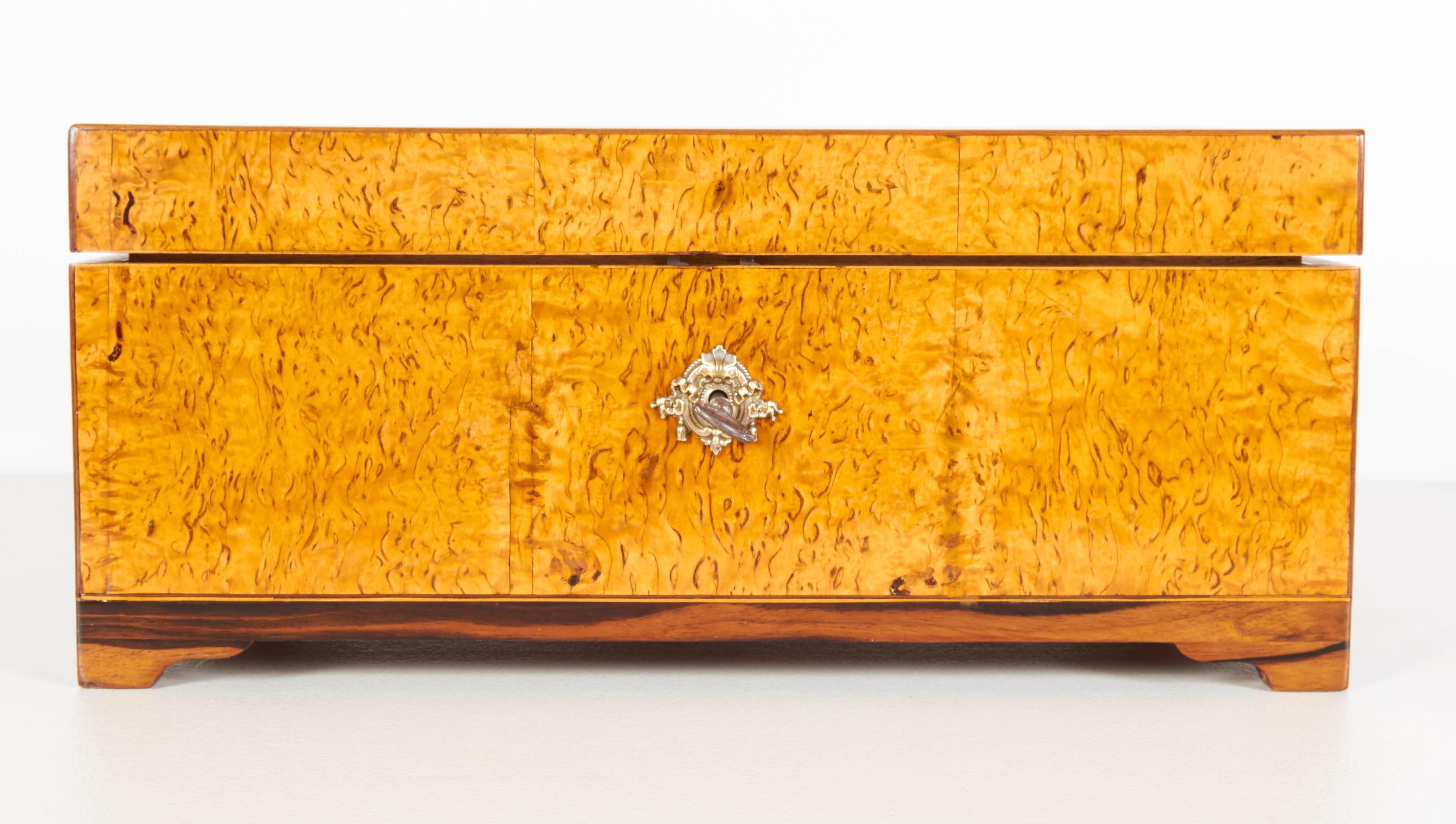 A fine Danish Empire inlaid birchroot, palisander and mahogany box, early 19th century, the rectangular hinged lid with an inlaid fan medallion, the fitted interior with numerous lidded compartments.