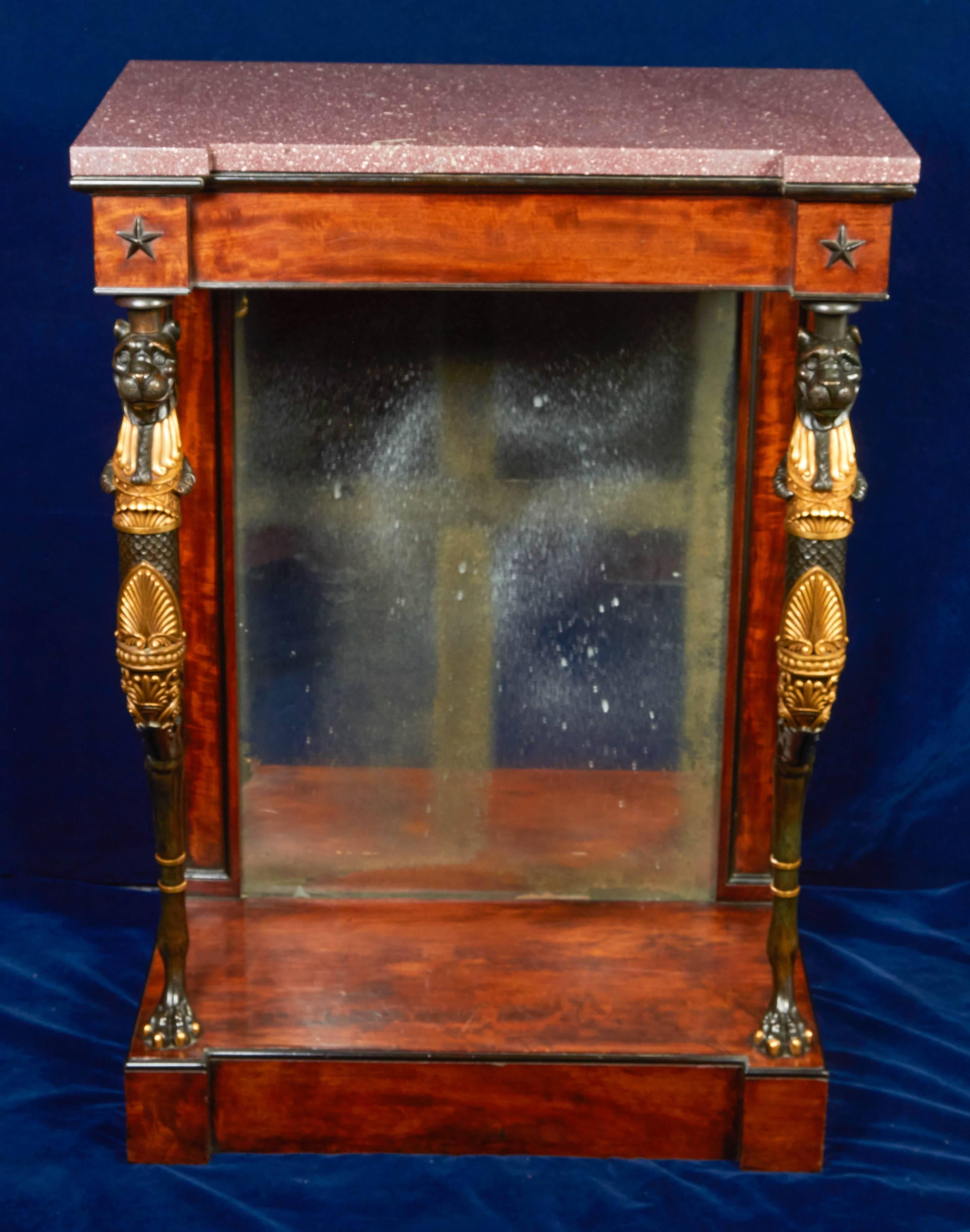 A very fine and rare pair of Regency part-ebonized mahogany gilt and patinated Bronze Console Tables in the manner of George Smith, early 1800s, circa 1810. Each side table with a Egyptian Porphory top; Each top above a conforming frieze with