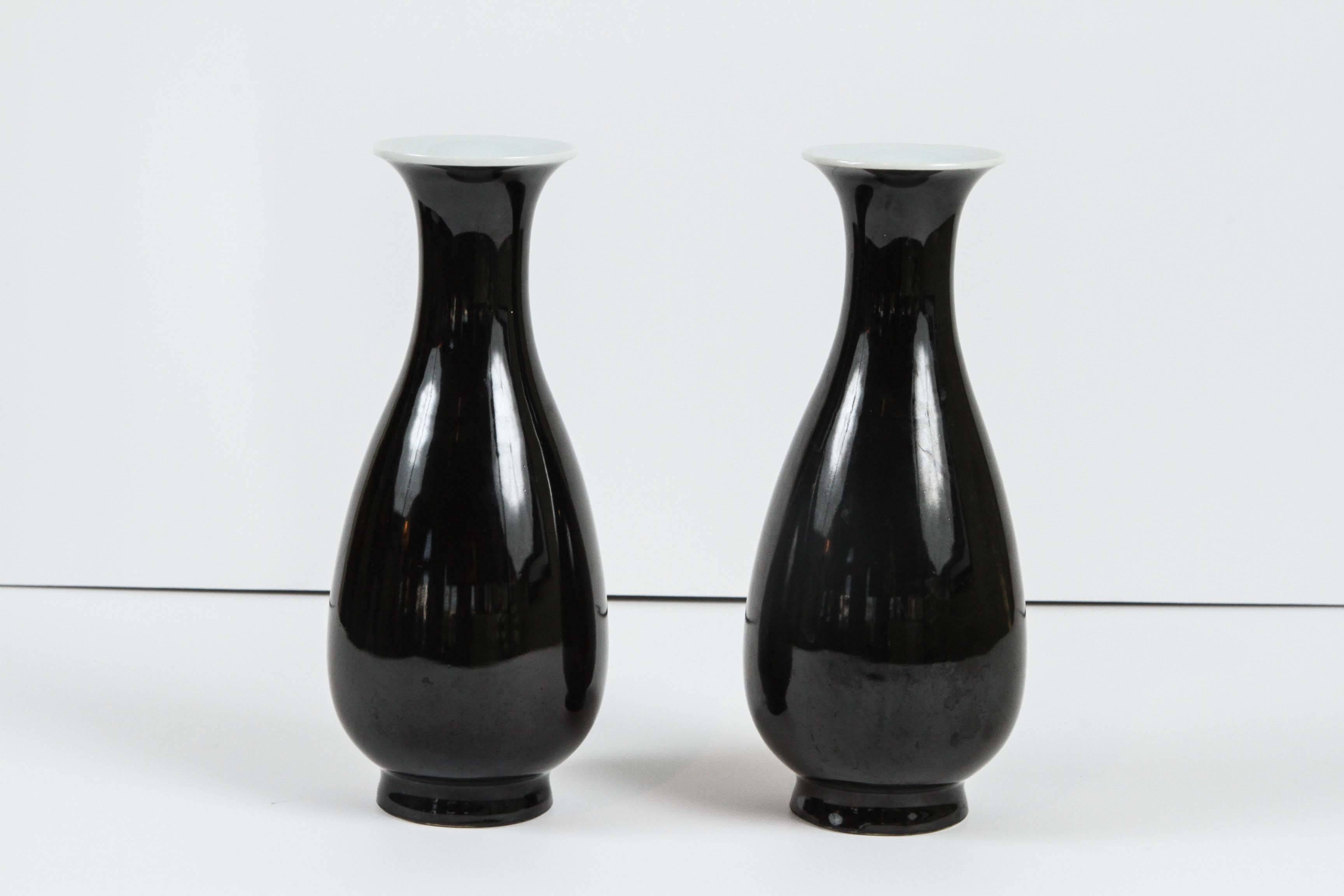 A pair of Chinese mirror-black glazed baluster form vases, circa 1850.