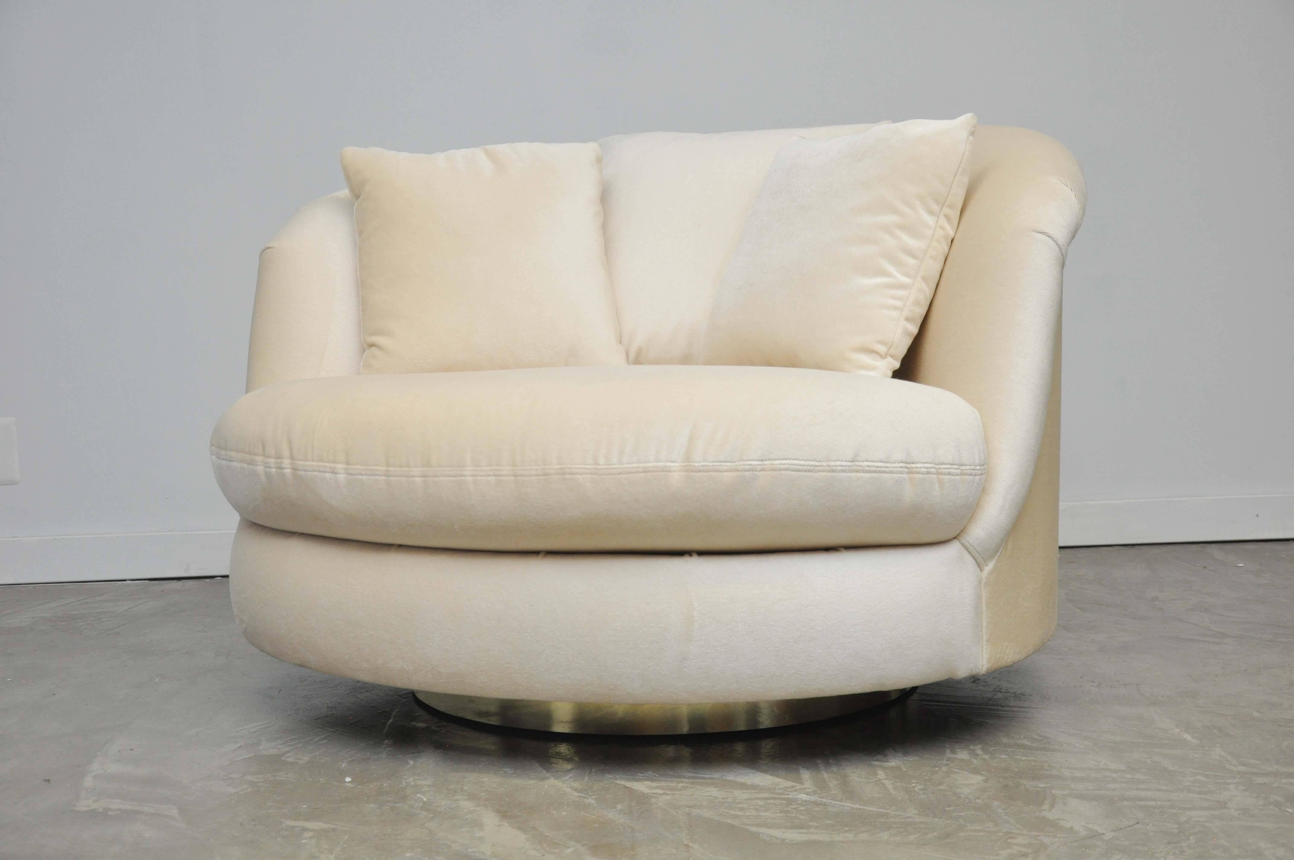 Large-scale swivel chair by Milo Baughman. Fully restored. New mohair upholstery over polished brass swivel base.